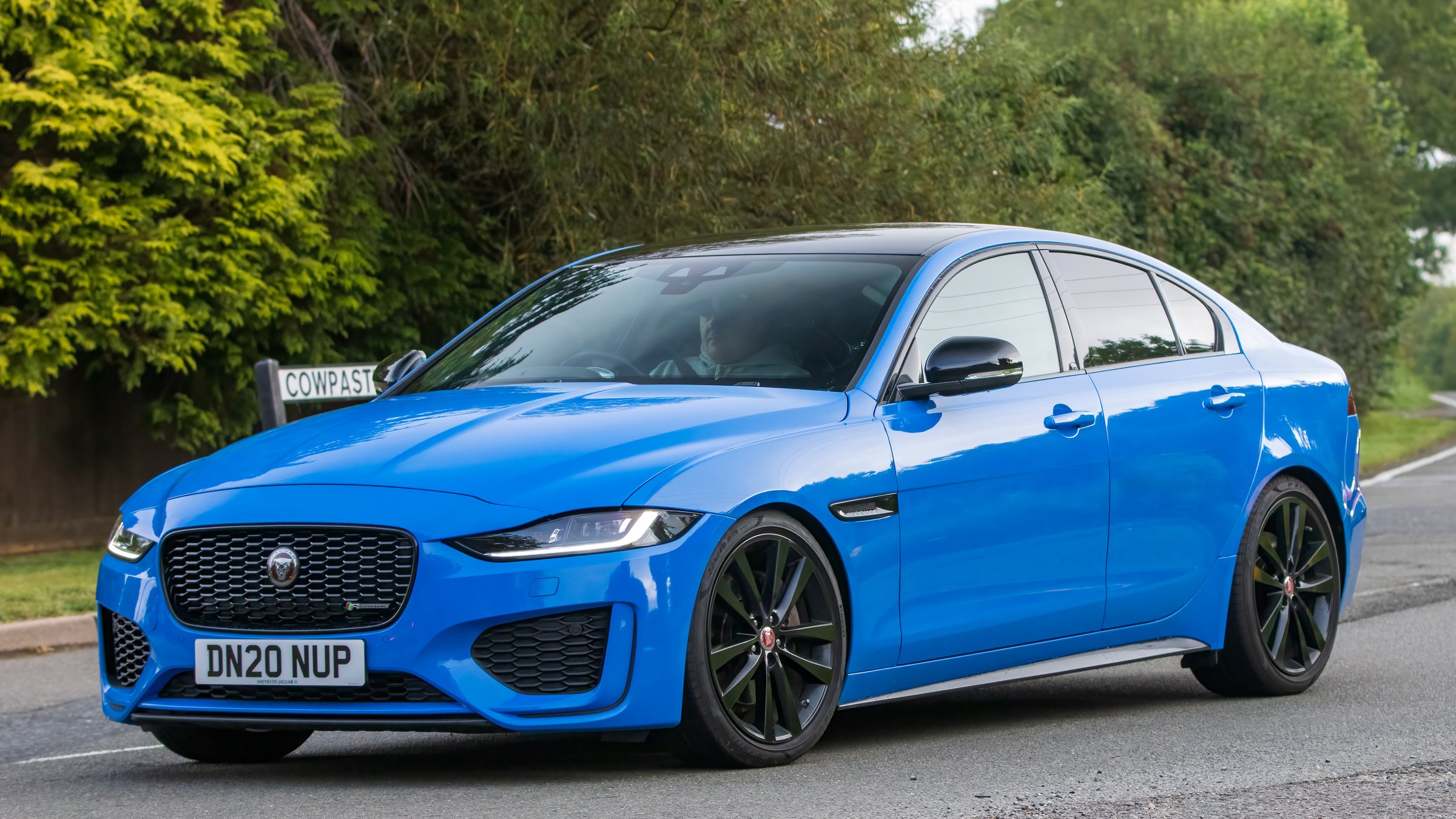 Whittlebury,Northants,UK -Aug 26th 2023:  2020 blue Jaguar XE Reims Edition travelling on an English country road