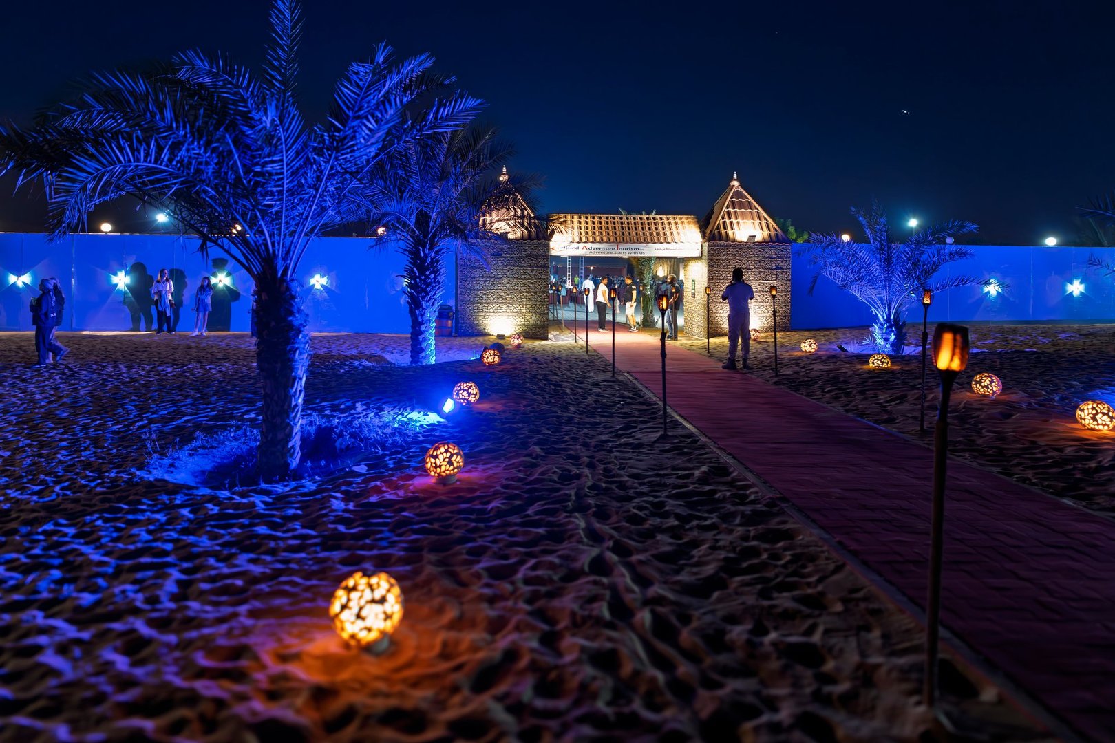 Exterior view of an illuminated desert safari camp and resort in the Sharjah Dubai desert, UAE, United Arab Emirates.