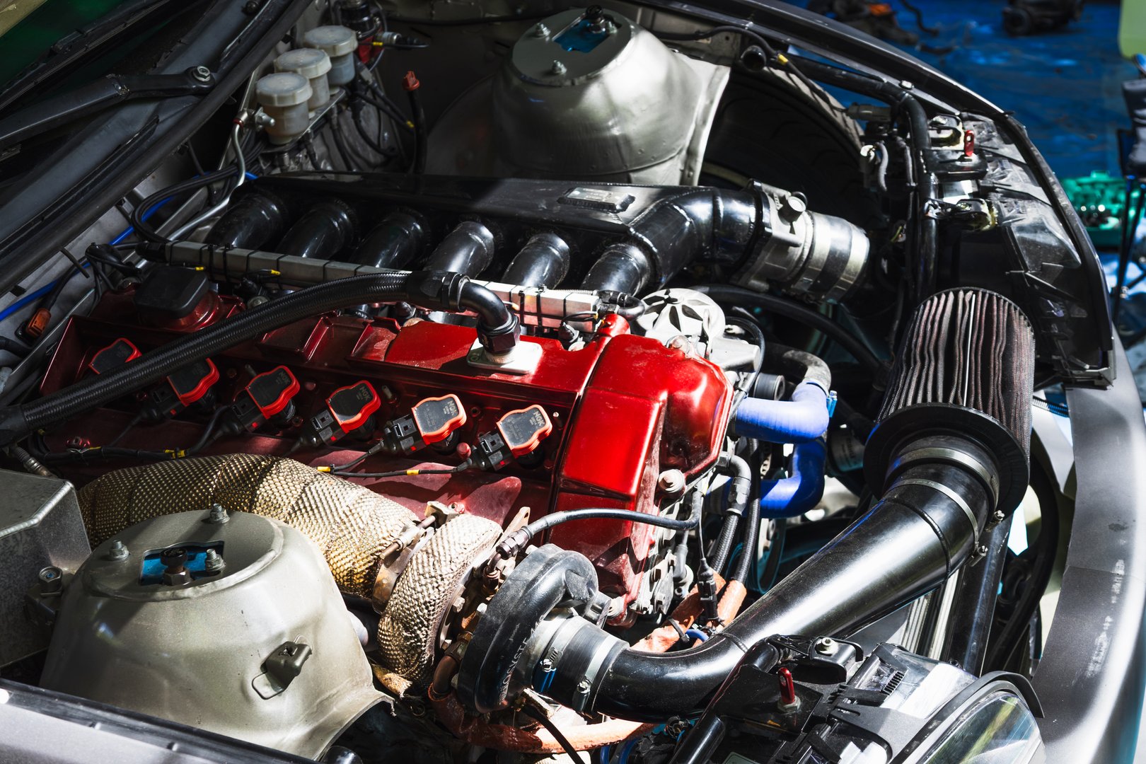 Macro of modified racing powerplant. Stainless turbo manifold, coil on plug ignition, braided lines and oil catch can symbol of horsepower and boost. Alytus, Lithuania, 25 May 2025