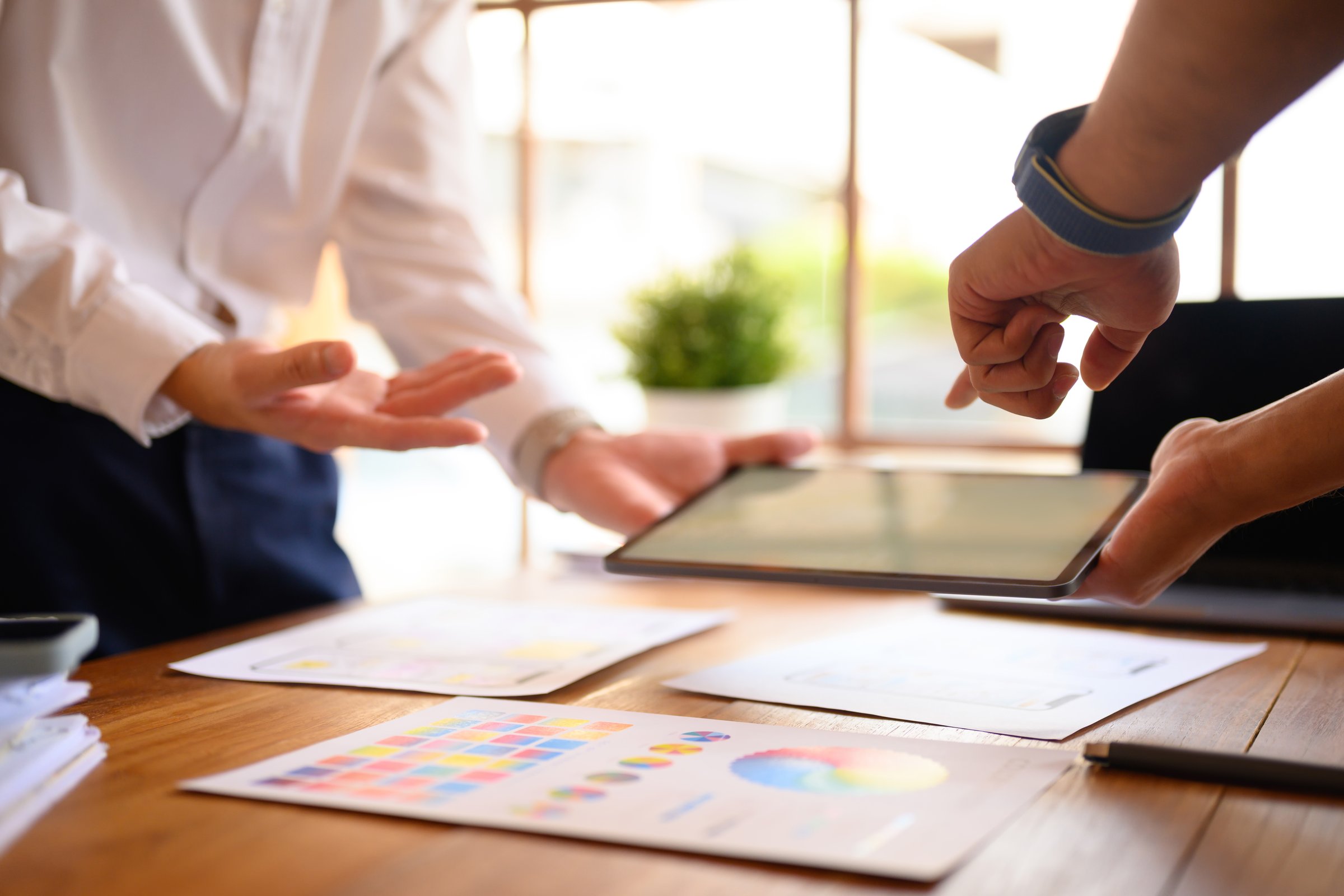 Two young creative designer working on mobile application software design project in office.