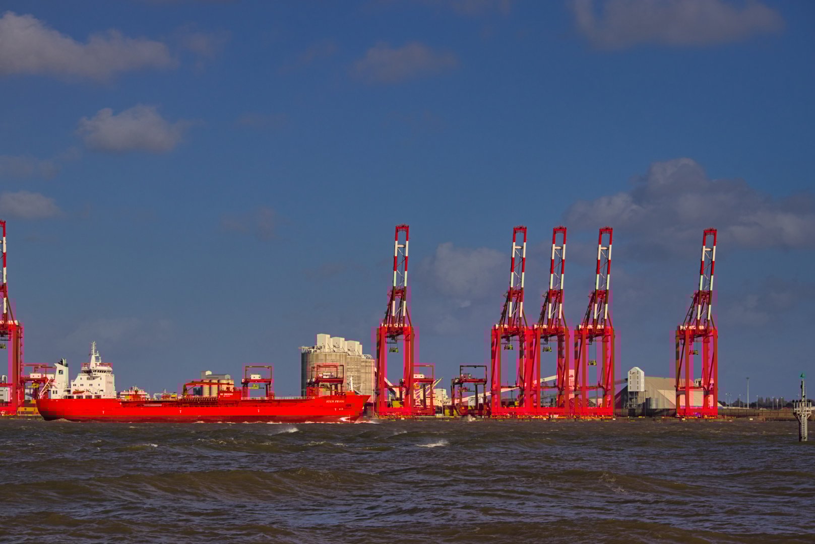 Industrial maritime transportation vessel sailing up river Mersey