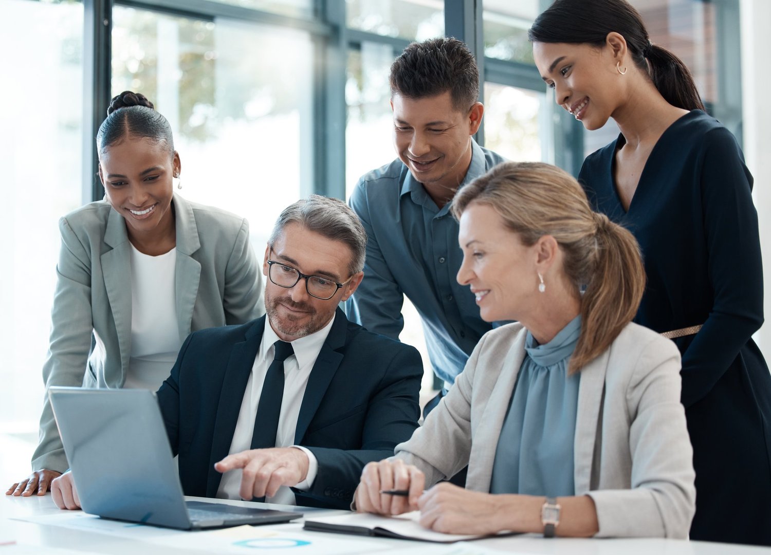 Business people, laptop and team collaboration for planning, strategy and sharing idea at the office. Group of employee workers in teamwork analysis, ideas or marketing plan on computer at workplace