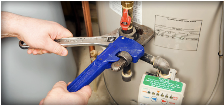 Plumber repairing hot water system