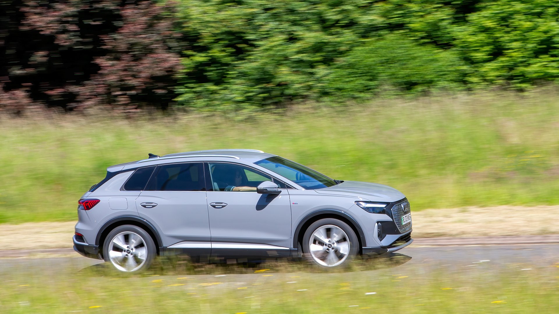 Milton Keynes,UK - June 20th 2024: 2022 grey Audi Q4 e-tron s line 40 electric  car driving on a British country road