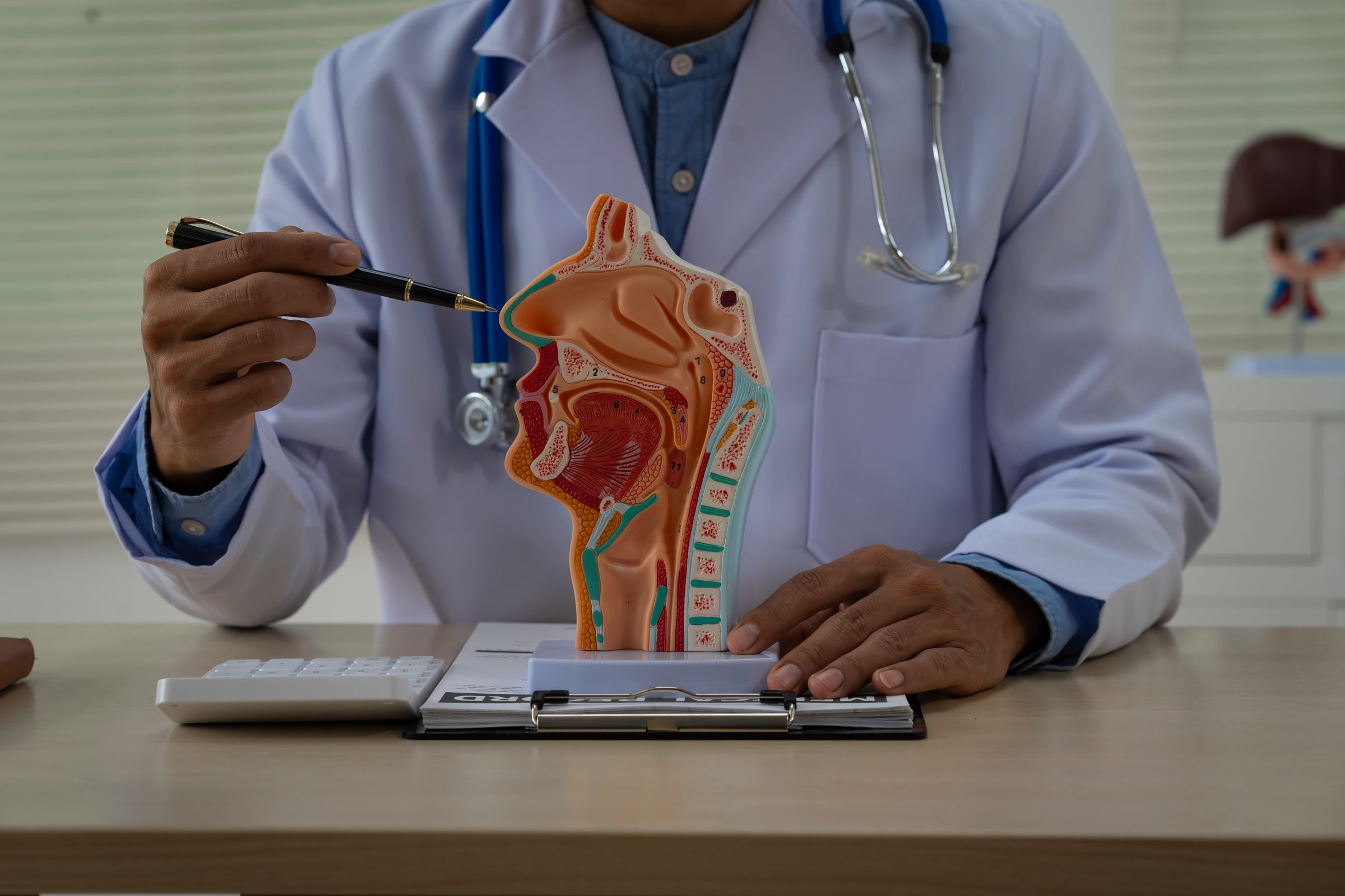 A male doctor sits at the table, explaining the respiratory and digestive systems, highlighting the critical roles of organs like the nose, lungs, and throat in maintaining life.