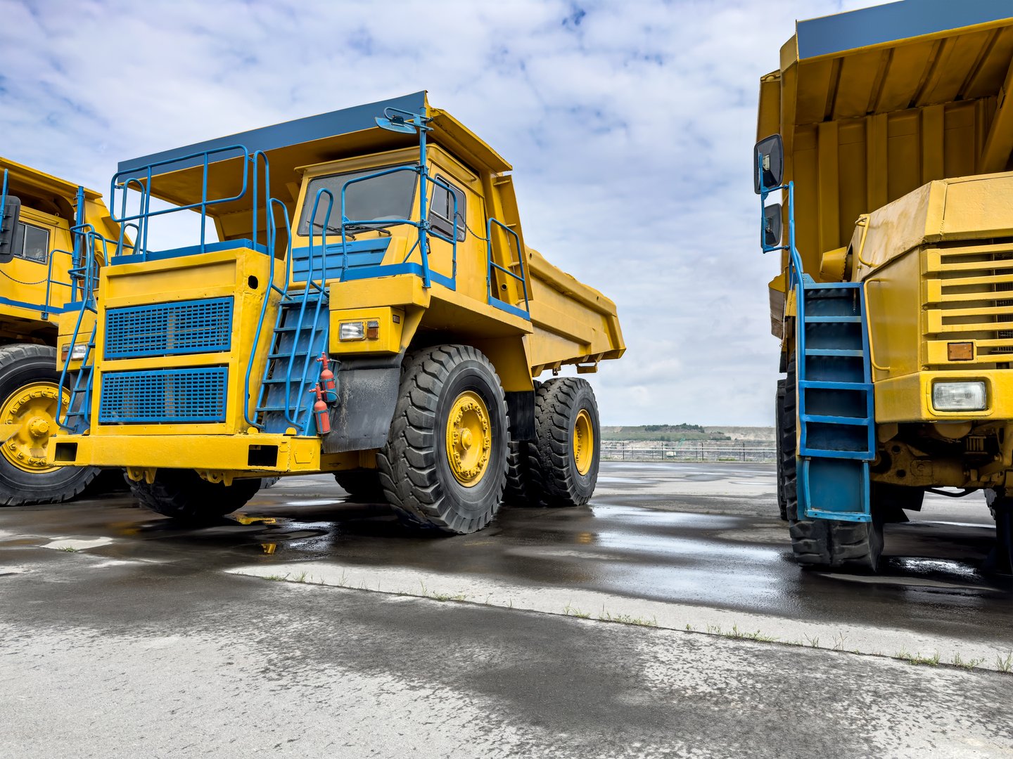 large yellow quarry dump trucks for transportation of minerals. mining machinery.