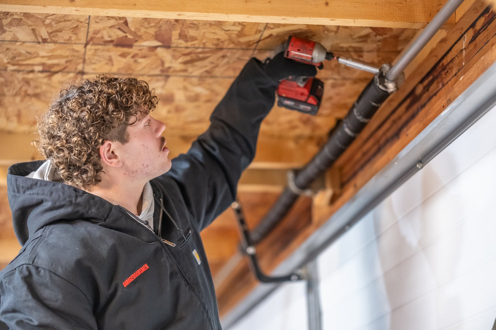 GarageDoorsMen technician performing repair
