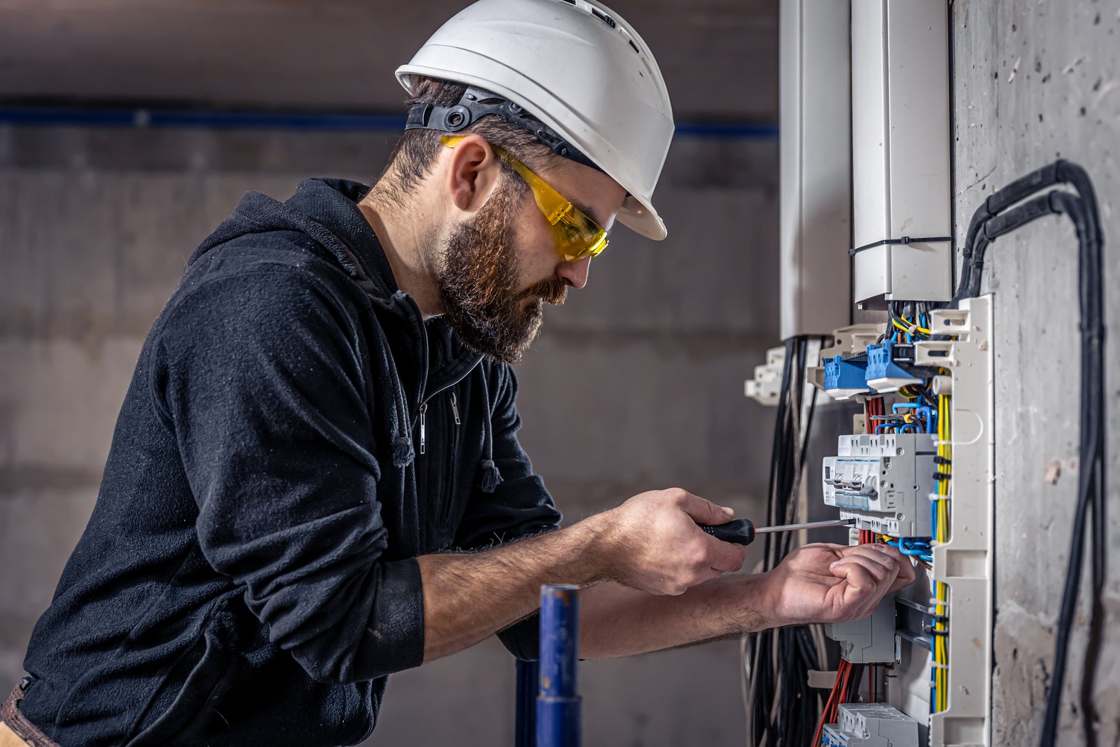 Electrician working on switchboard