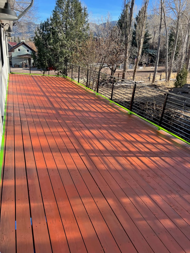 Custom wood deck with black metal railing built by Griffin Renovation in Cache Valley, Utah