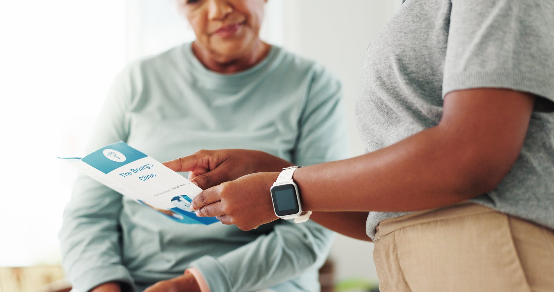 Clinic, patient and doctor with brochure for consultation, diagnosis information and healthcare service. Hands, medical consultant and senior woman with pamphlet for advice, recovery tips and support