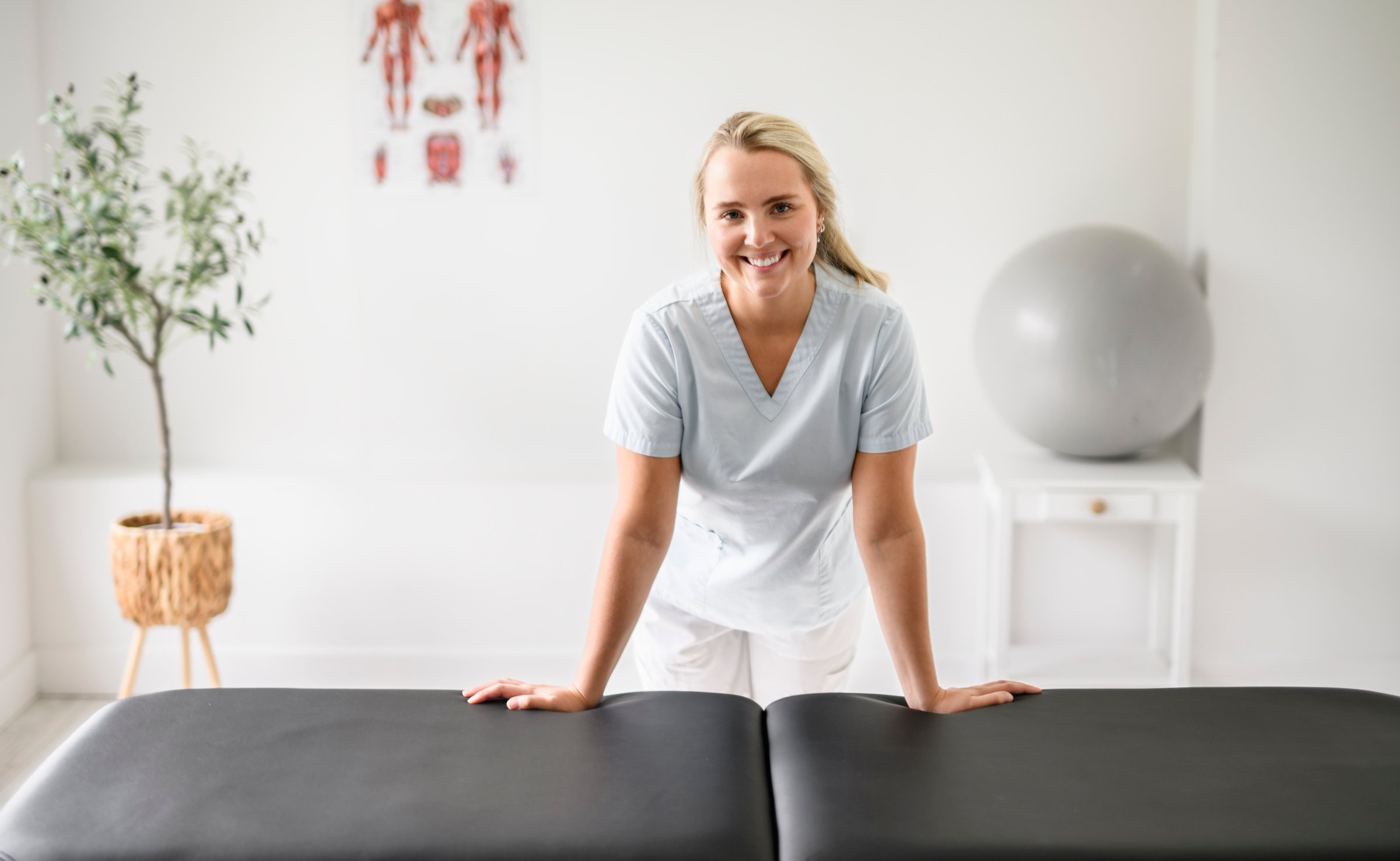 A nice blond physiotherapist woman at job