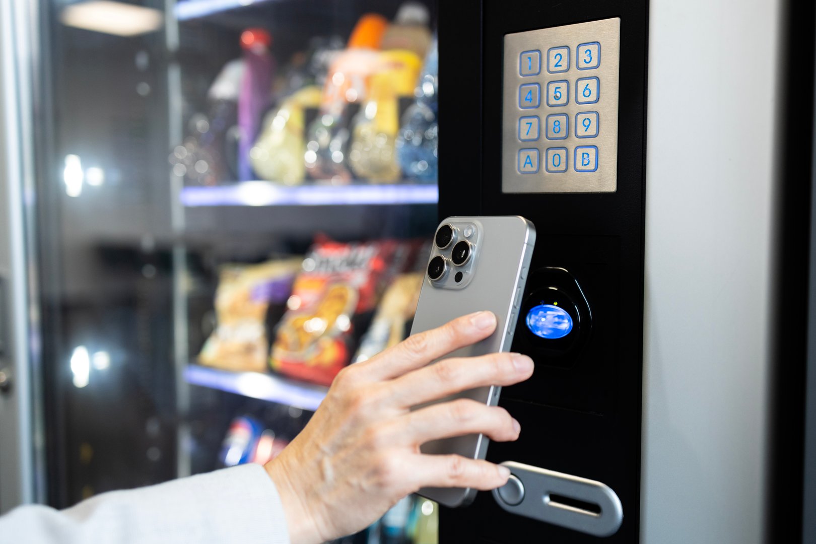 Woman making contactless payment at vending machine