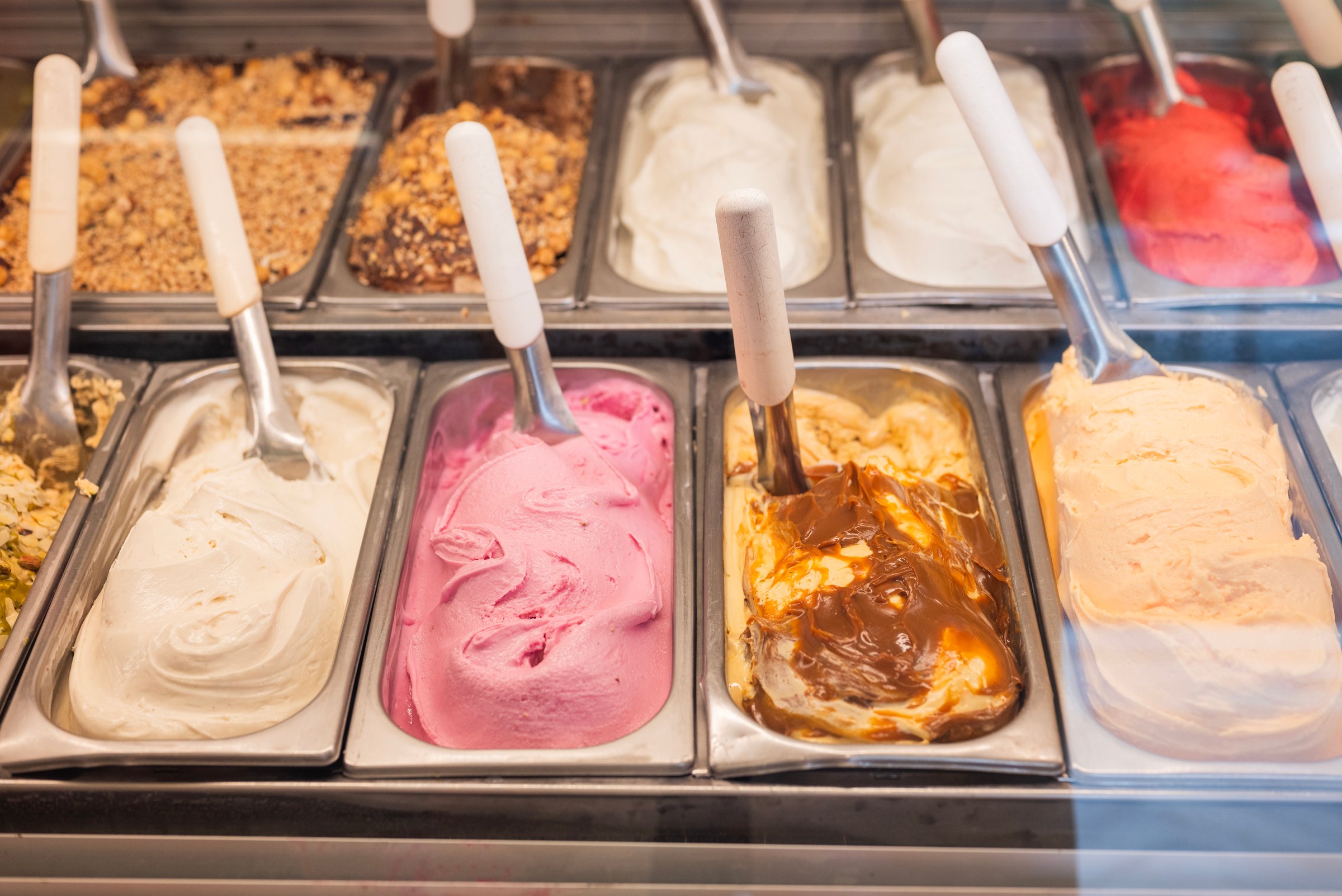 display case in a cafe with different types of gelato ice cream in Italy