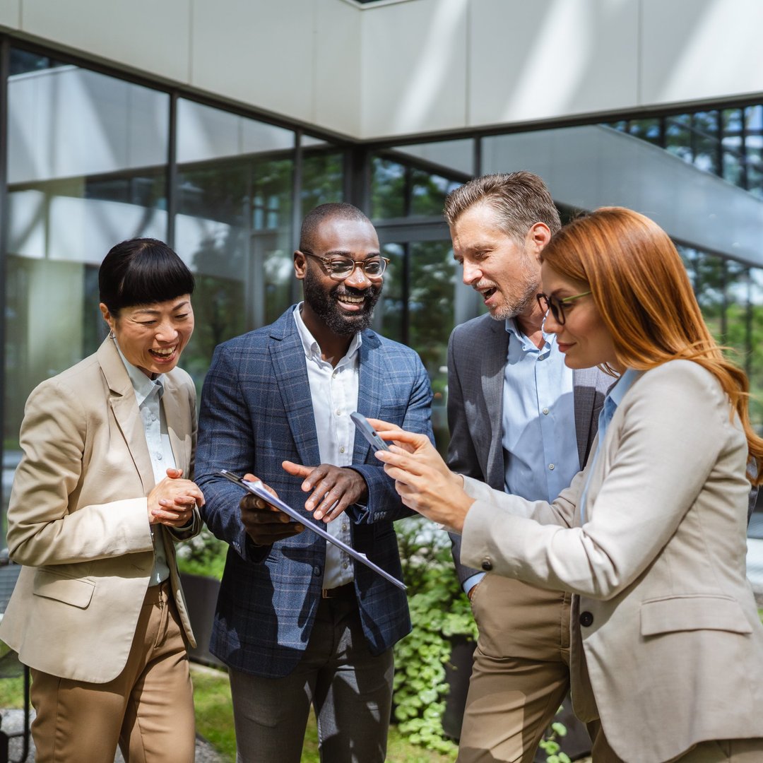 Group of diverse business person work together in front company building, african american man hold clipboard, while caucasian woman take a photo or scan document