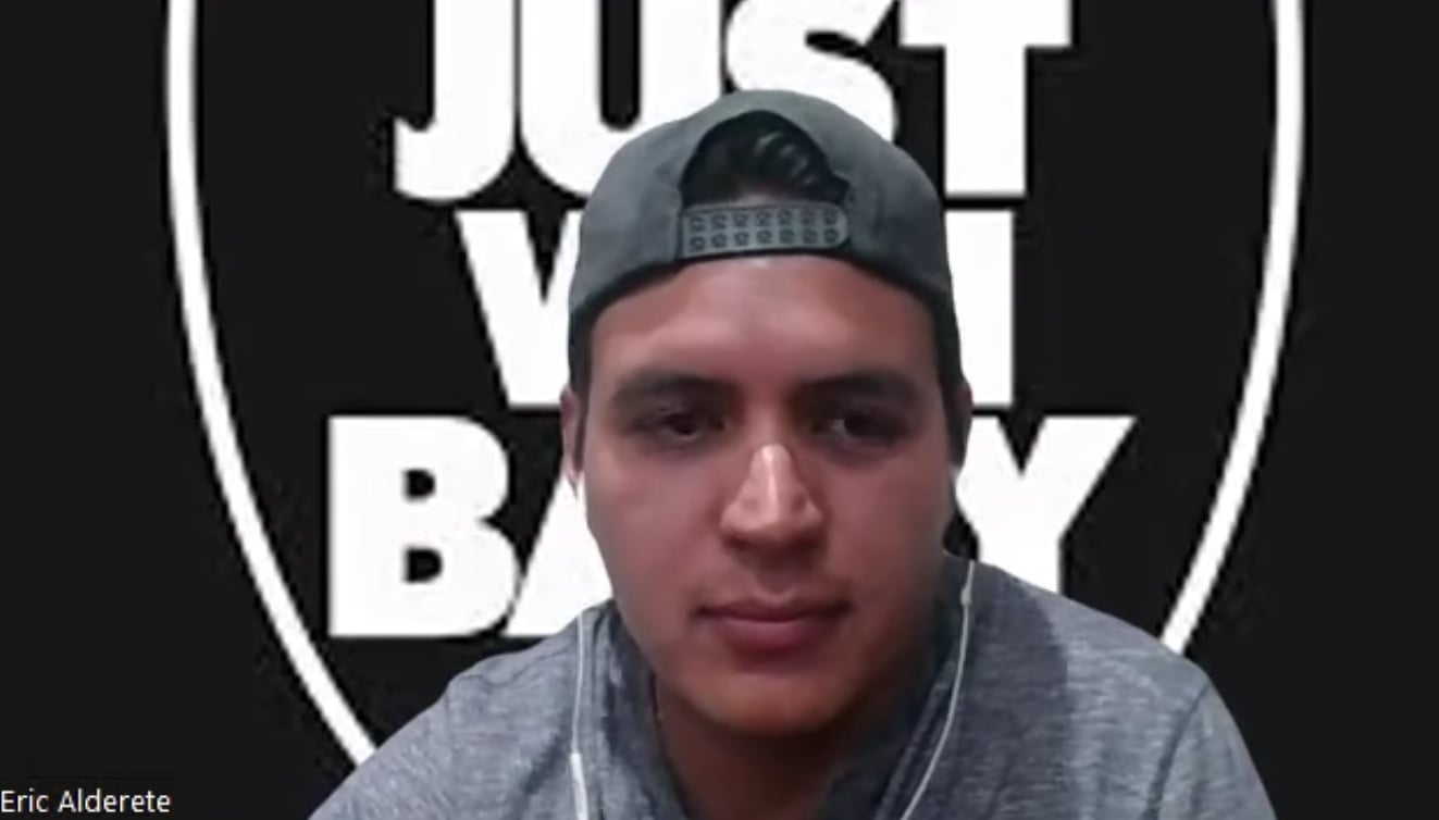 Person wearing a baseball cap and earphones, in front of a black and white background with bold text.