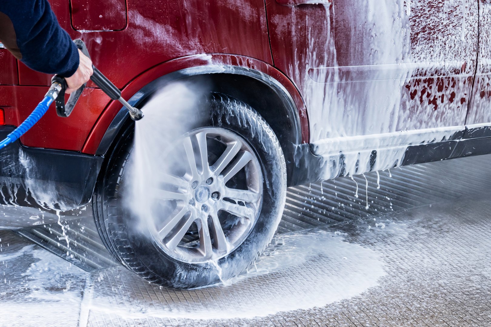 Washing red car in hand car wash