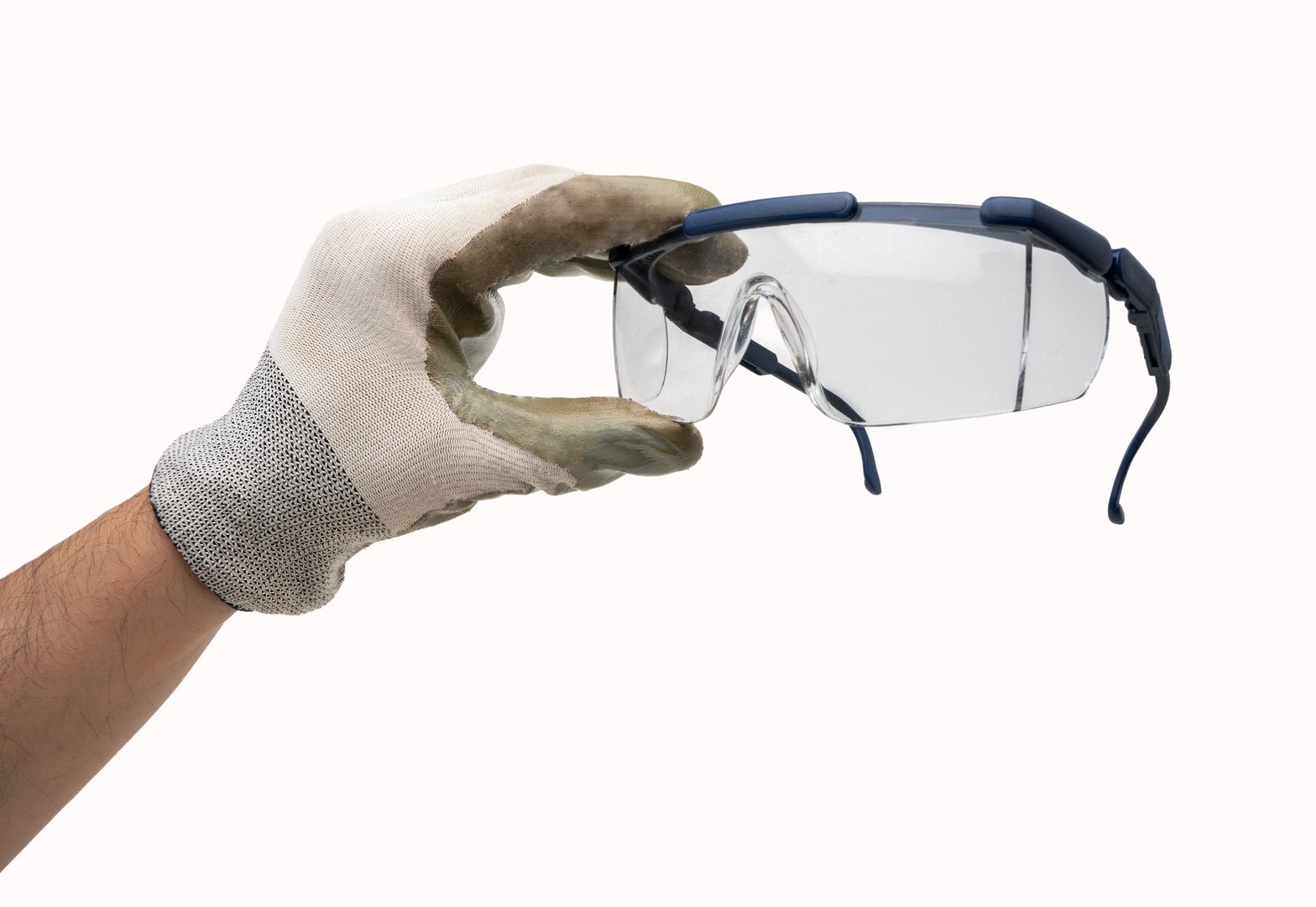 Hand with working glove holding protective glasses. Isolated on white background.