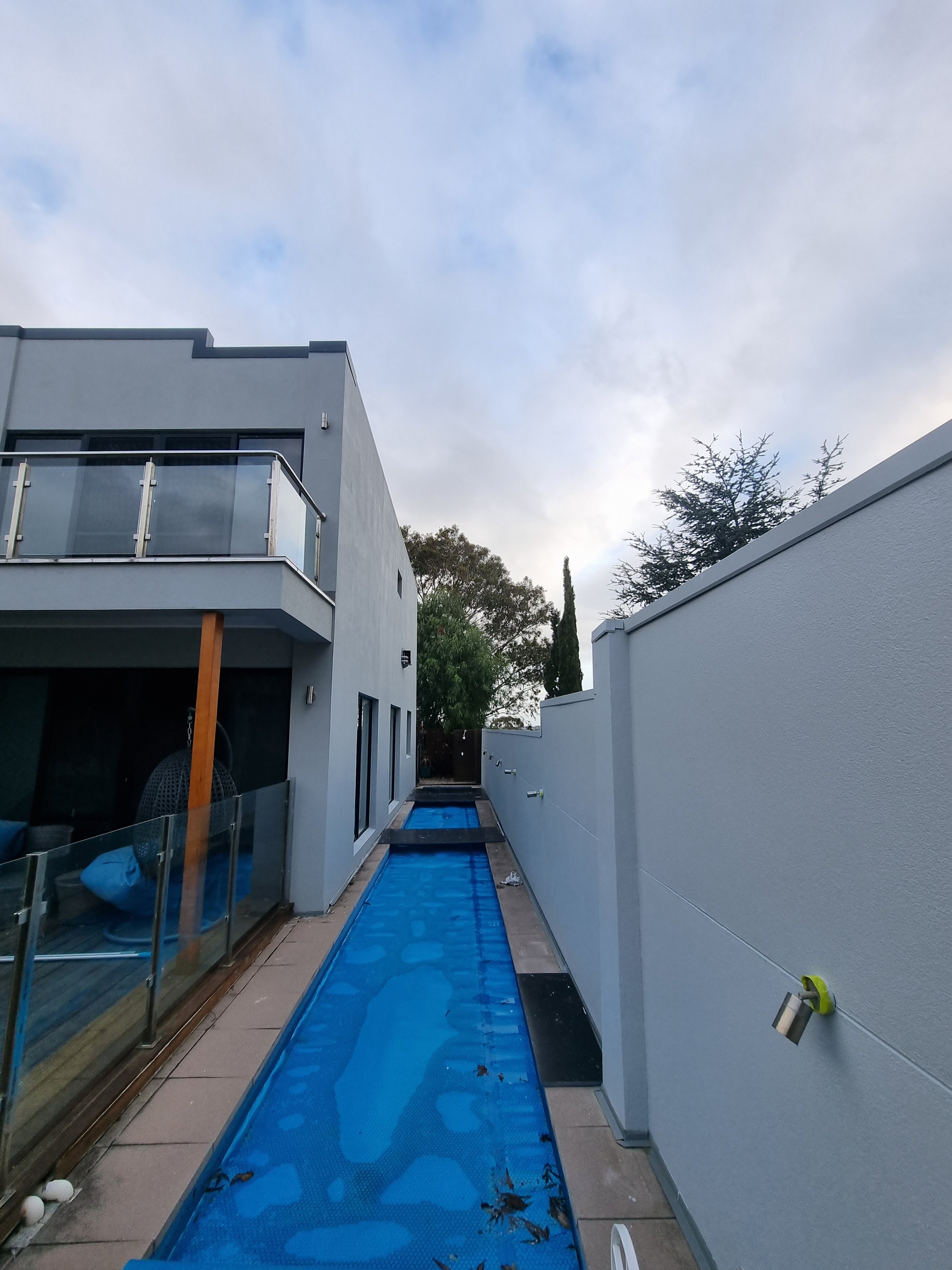 Rendered cladding restoration showing professional coating application technique