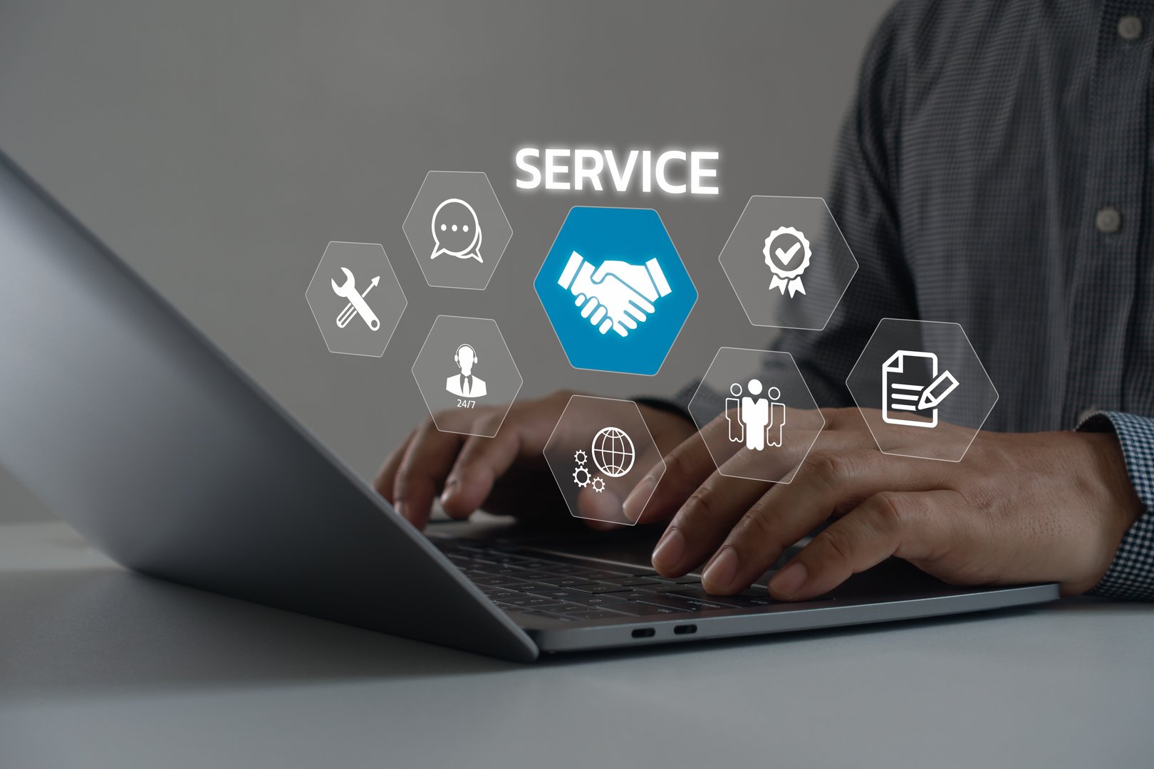 Technical support operator with virtual screen icon working on laptop computer. Help desk IT support call center online technology. Customer service and business warranty quality assurance concept.