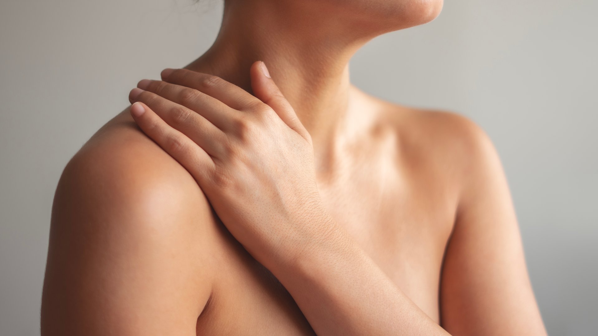 Woman applying body cream on arm, beauty skin care concept