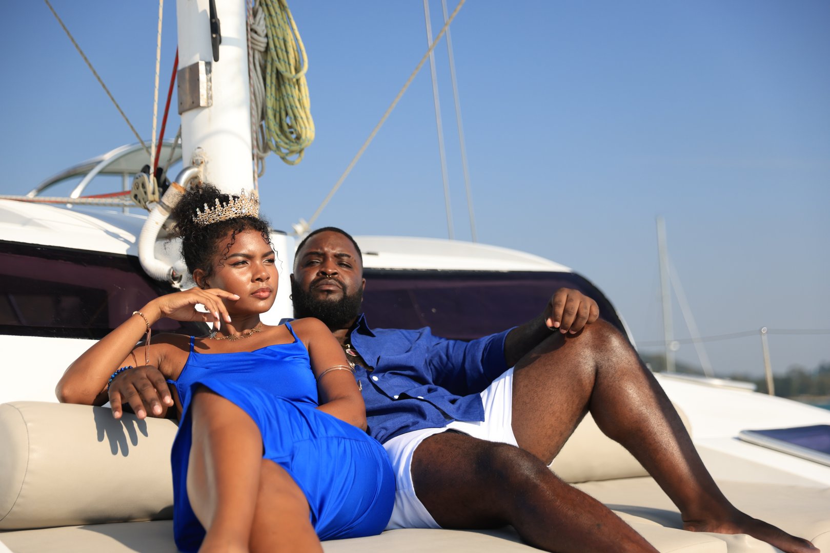 A vibrant Black couple enjoying quality time together on a yacht while celebrating the female's birthday.