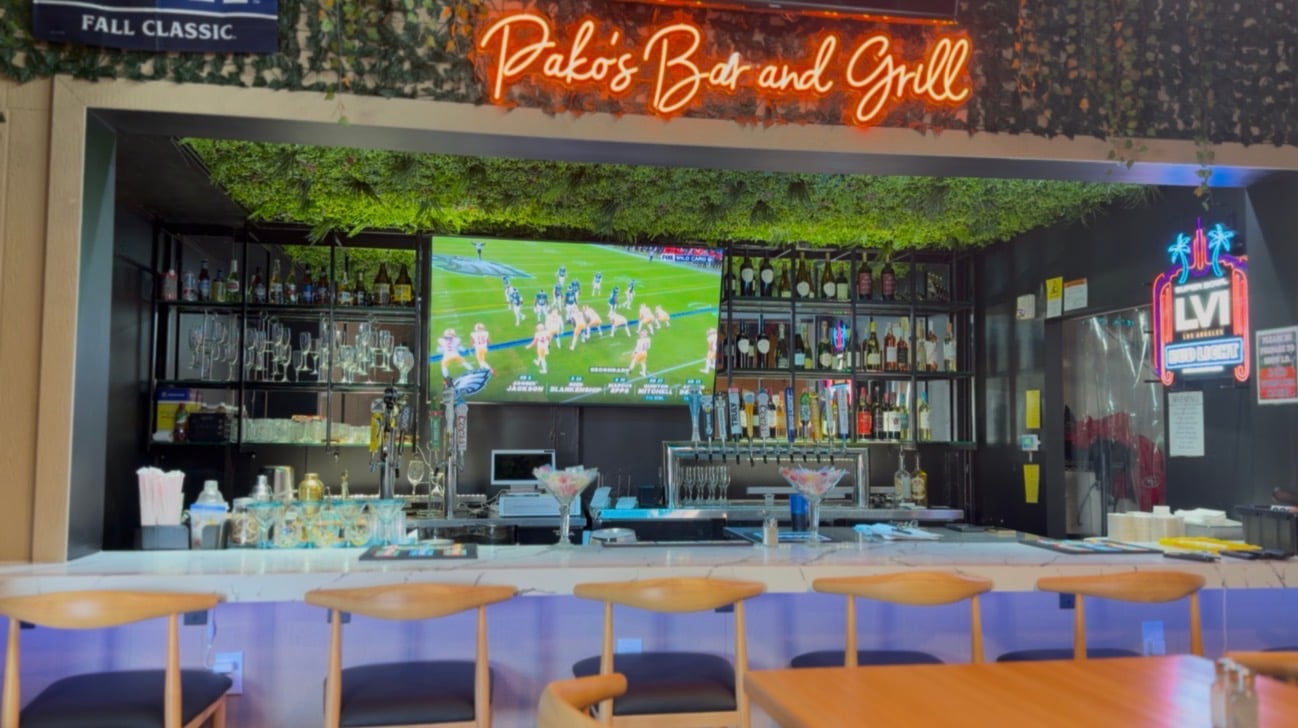 Pakos Bar and Grill bar area with TVs and seating
