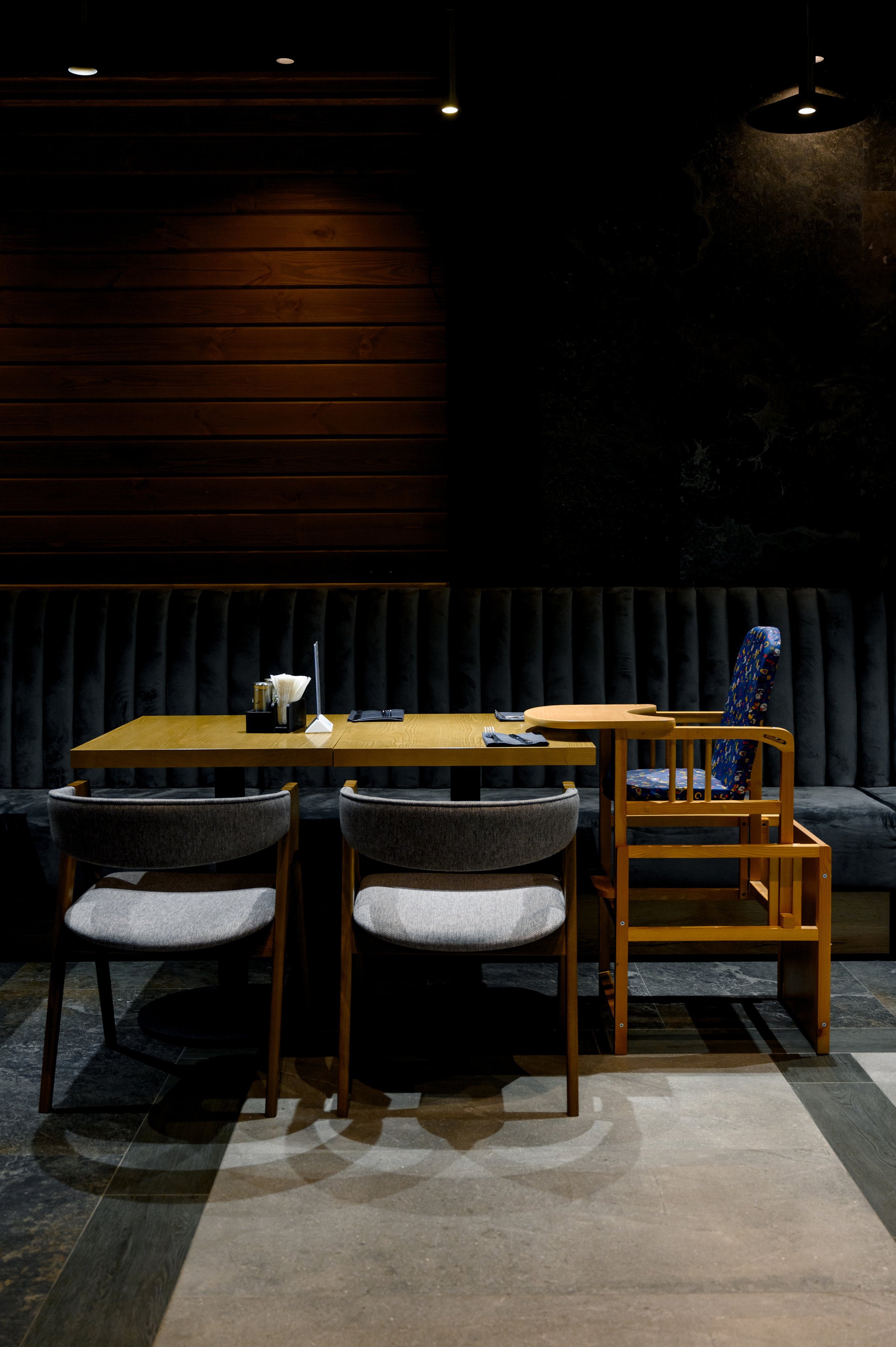 Restaurant interior with wooden table, chairs and children's chair. Concept of family restaurants, cafes and recreation areas