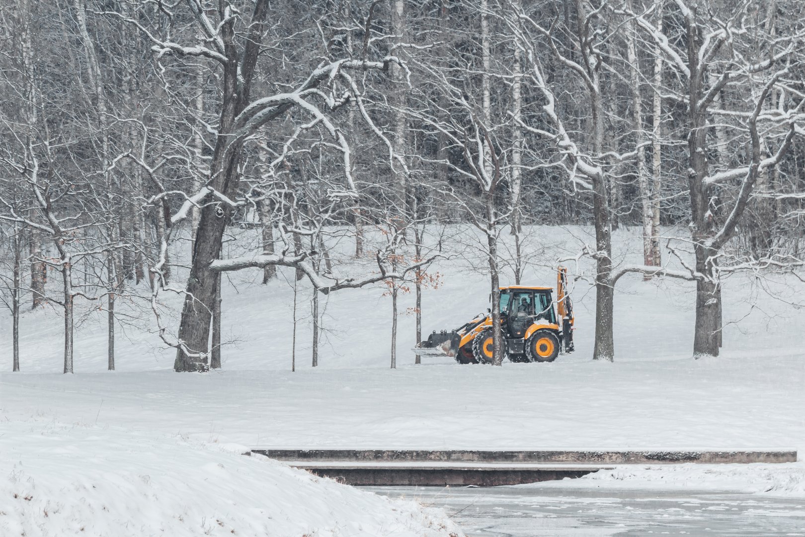 Tractor removes clean snow from the road Element Snow Hurricane Utilities Cleaning Snow
