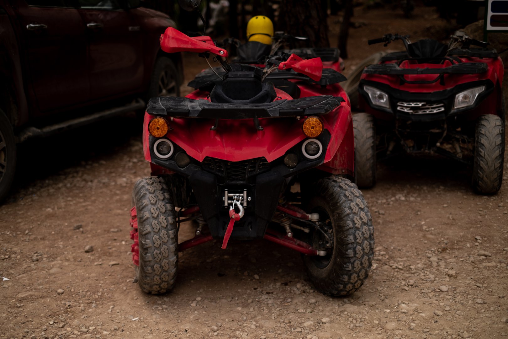In a forest clearing stands an ATV, promoting ATV and powersports sales. It also signifies adventure tours, active recreation, and extreme sports events.