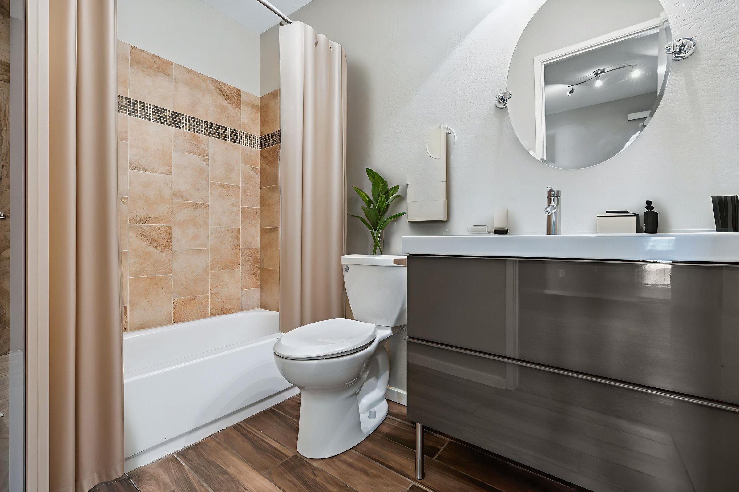 A well-equipped bathroom that includes essential features such as a toilet, sink, and shower, designed for comfort and functionality