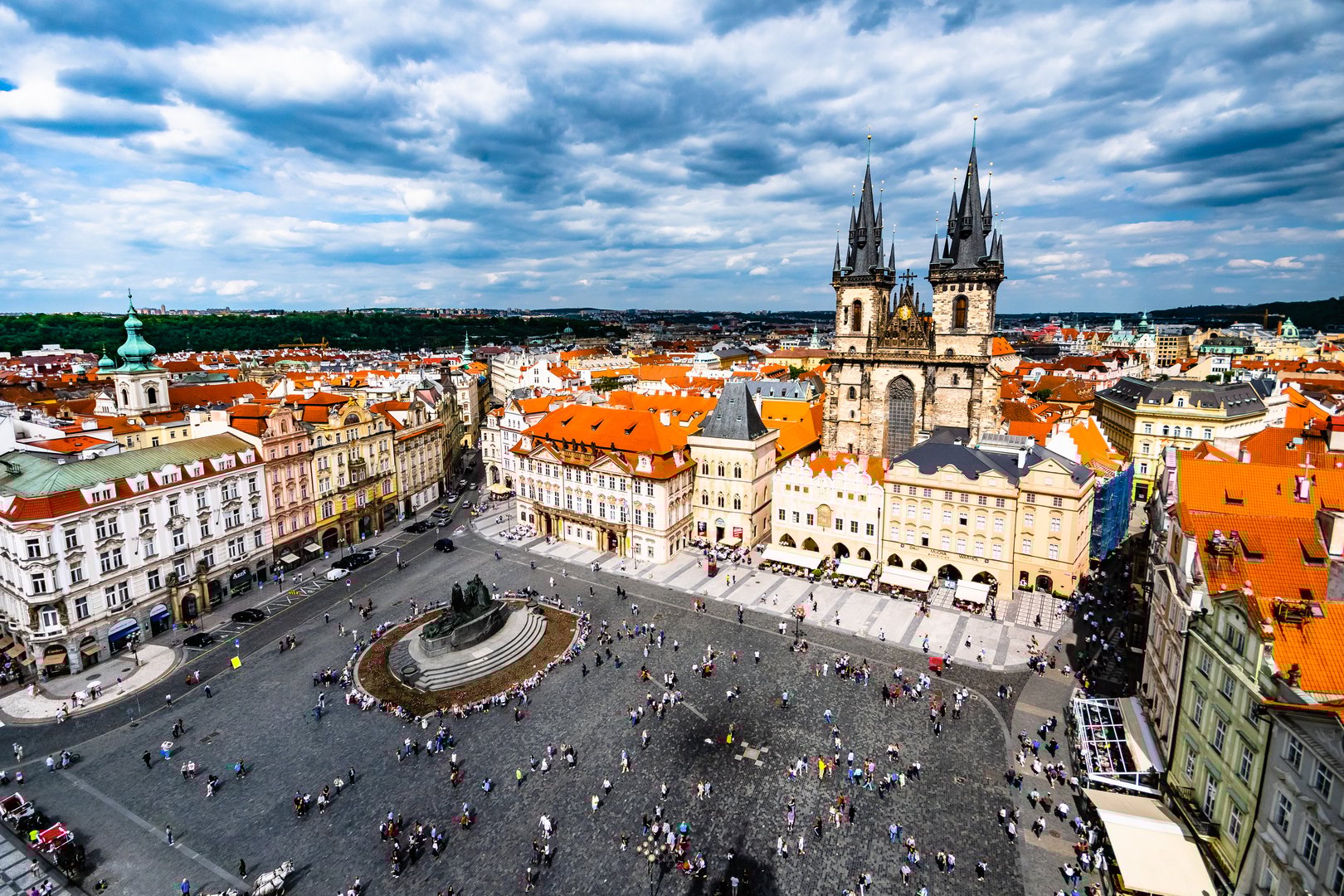 View of Prague Old Town Square with the Church of Our Lady before Týn
(Chrám Matky Boží před Týnem) taken from the clock tower of the Old Town Hall with dramatic cloudy sky and historic buildings