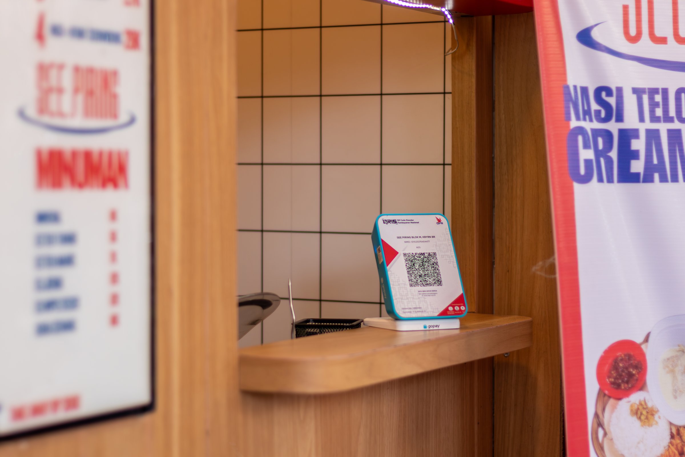Jakarta, Indonesia - August 02, 2025: A QR code or QRIS payment machine at a food stall. Payment method in Indonesia for mobile payments.