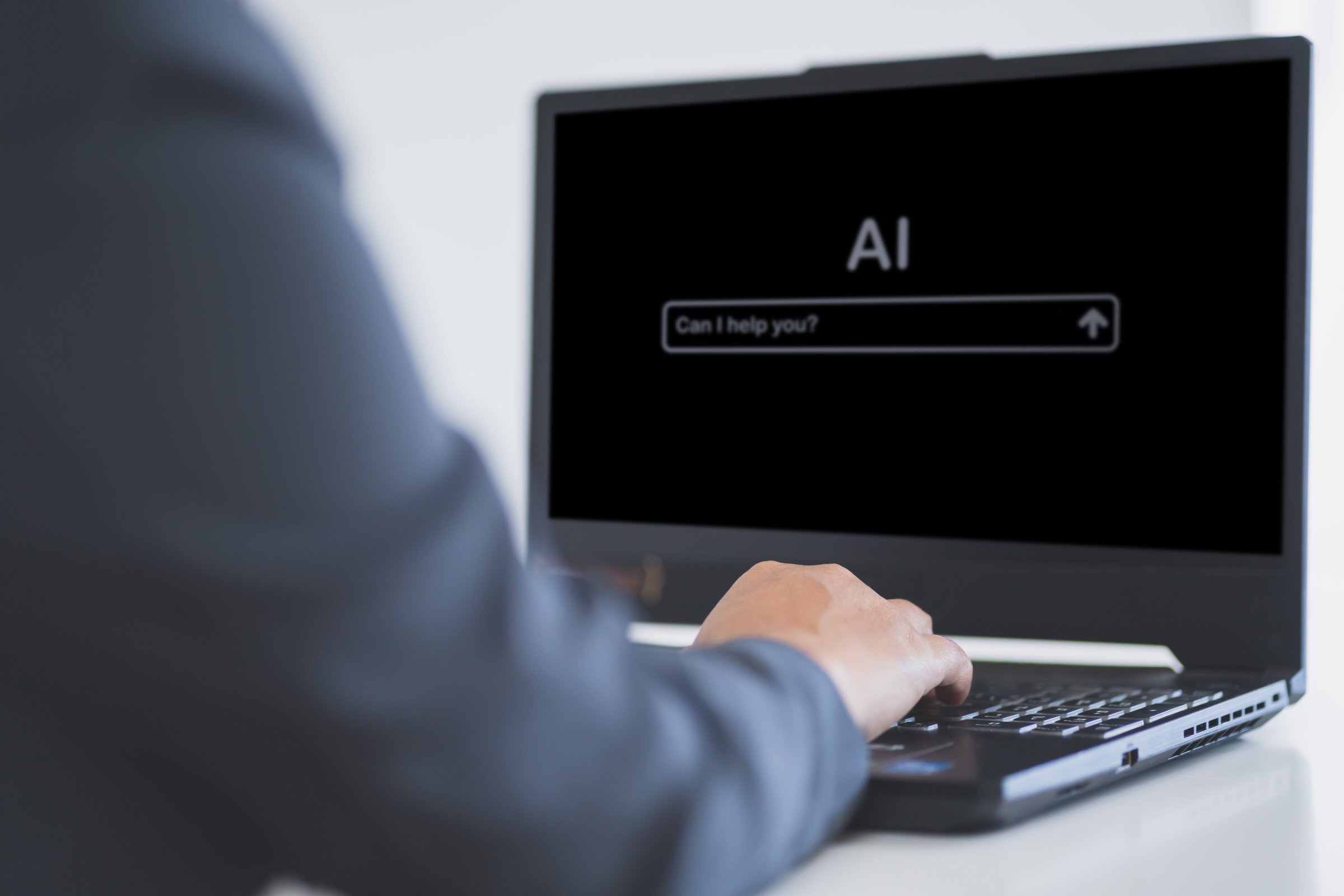 Business professional using laptop with AI interface