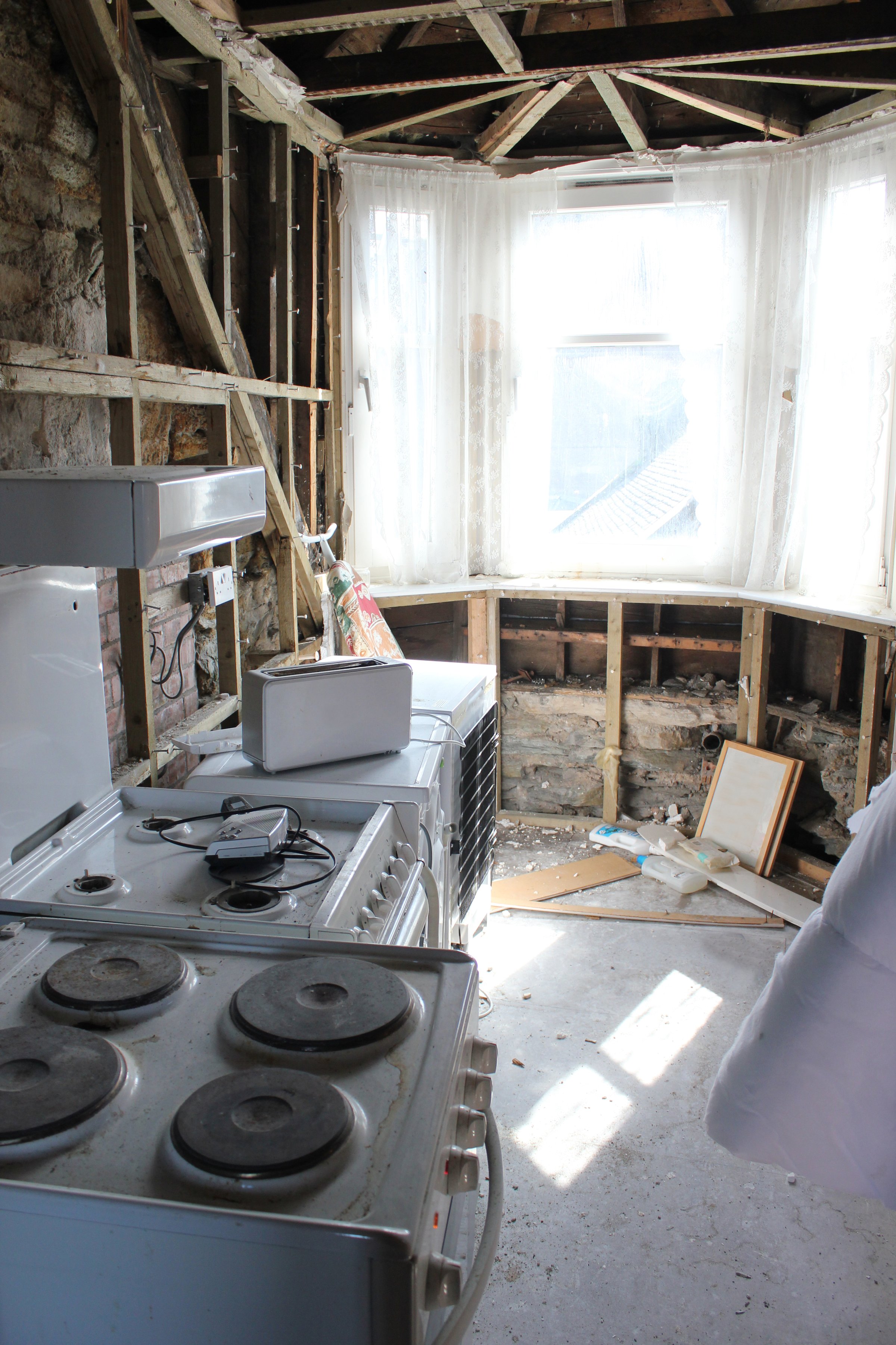 Gutted kitchen with exposed studs torn out renovation needed