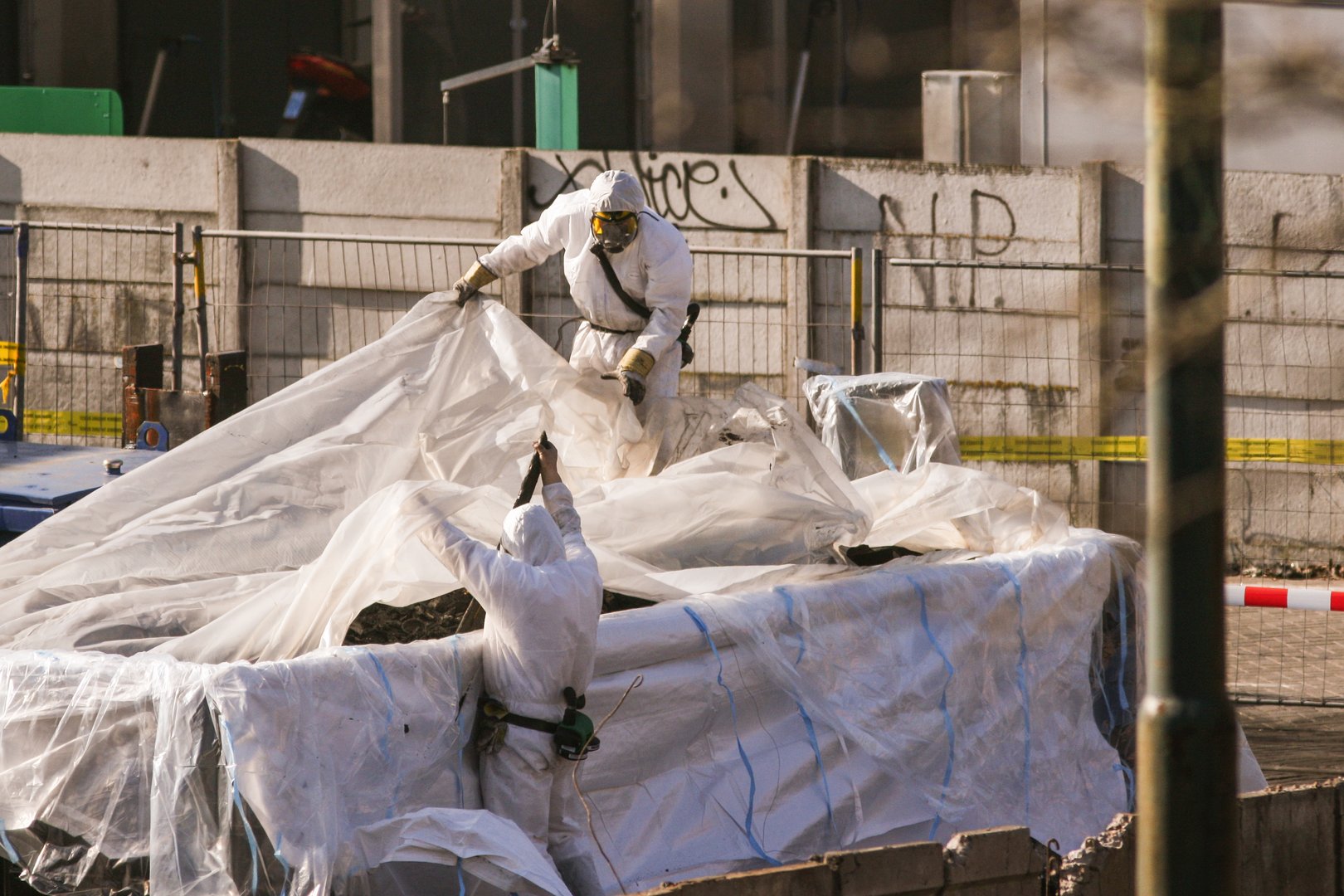 Removing asbestos after major fire in Havenstraat, Amsterdam, 3/9/2010, The Netherlands.Asbestos removal in the Netherlands is subject to strict rules. It is mandatory to wear protective clothing suitable for working with asbestos during the work. Suitable clothing is, for example, special disposable overalls and washable footwear or safety boots. A P3 half-face mask should preferably be worn during work.