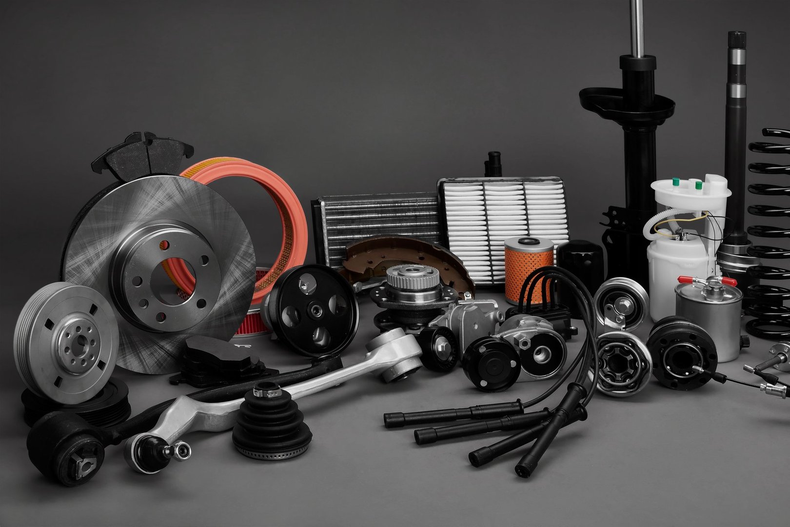 New car wheels and filters on a gray background. Parts closeup on a gray background