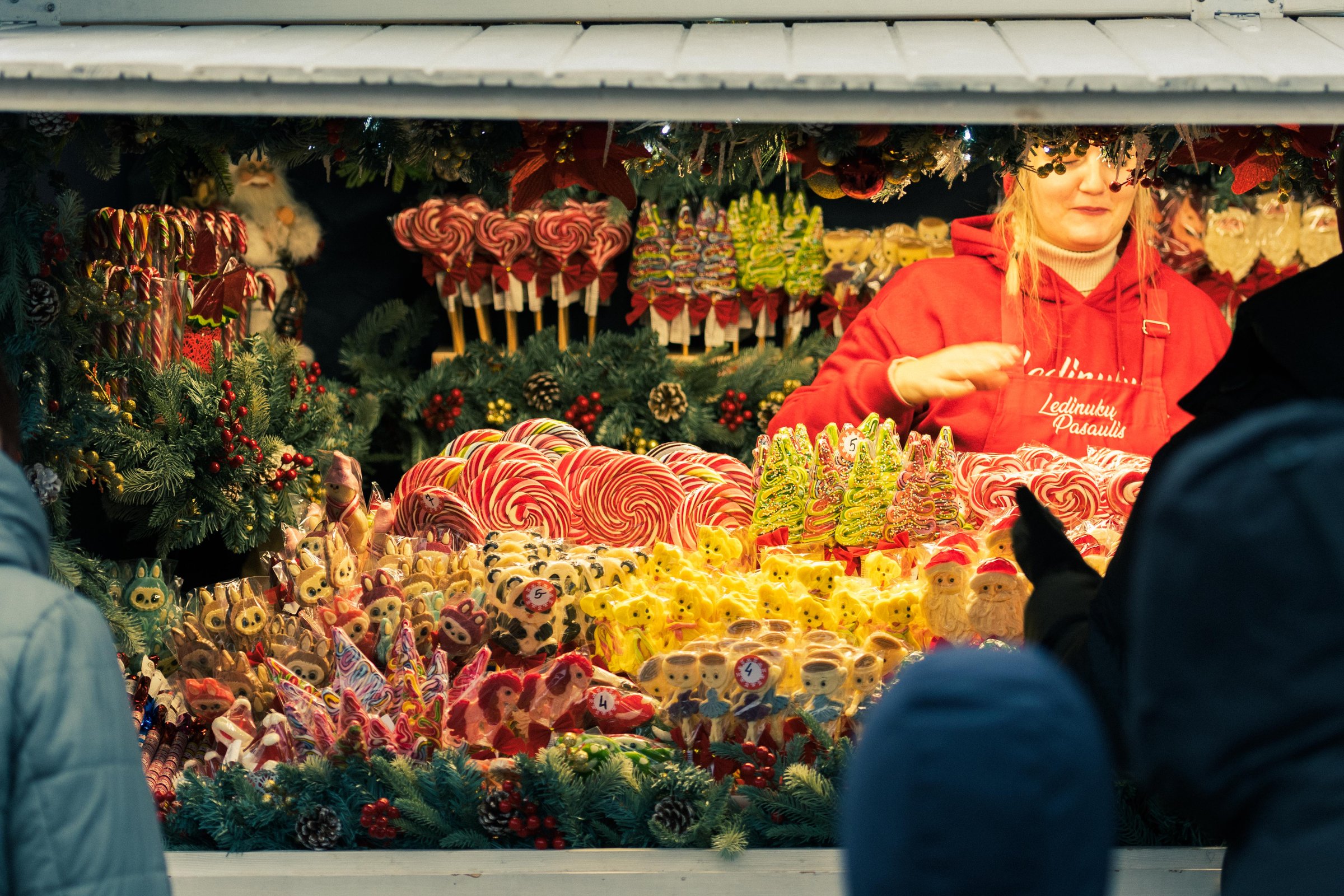 Vilnius, Lithuania - November 2025: Stall or stand with traditional colorful and festive candies and lollipops at the Christmas Market