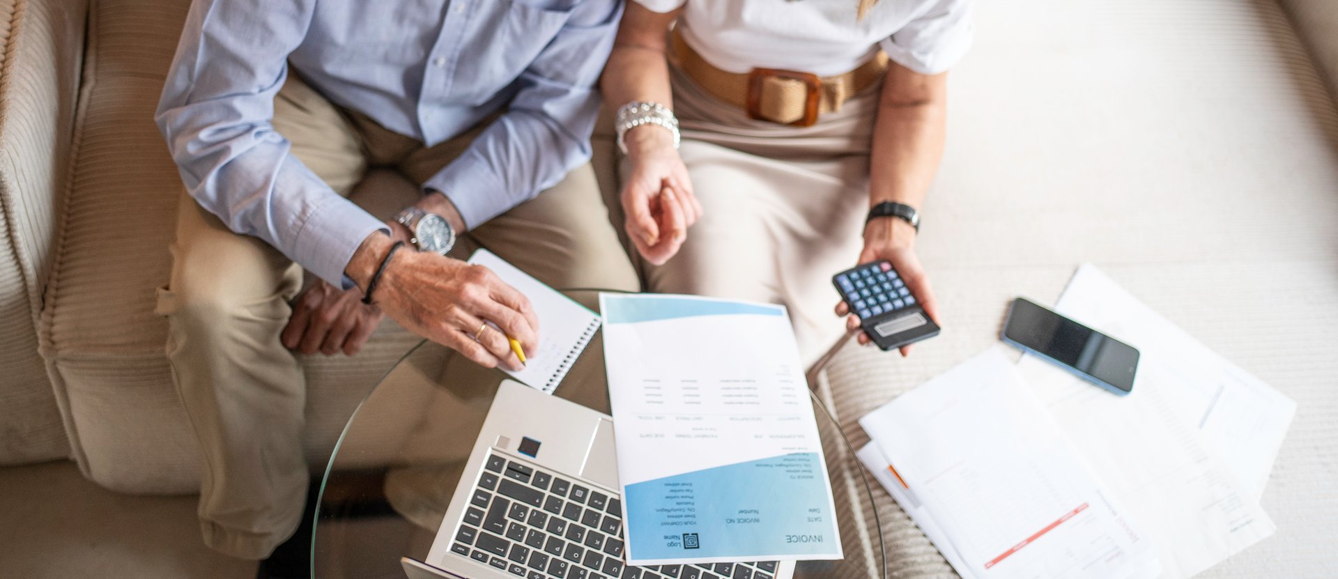 Senior couple calculating expenses and reviewing documents for financial planning