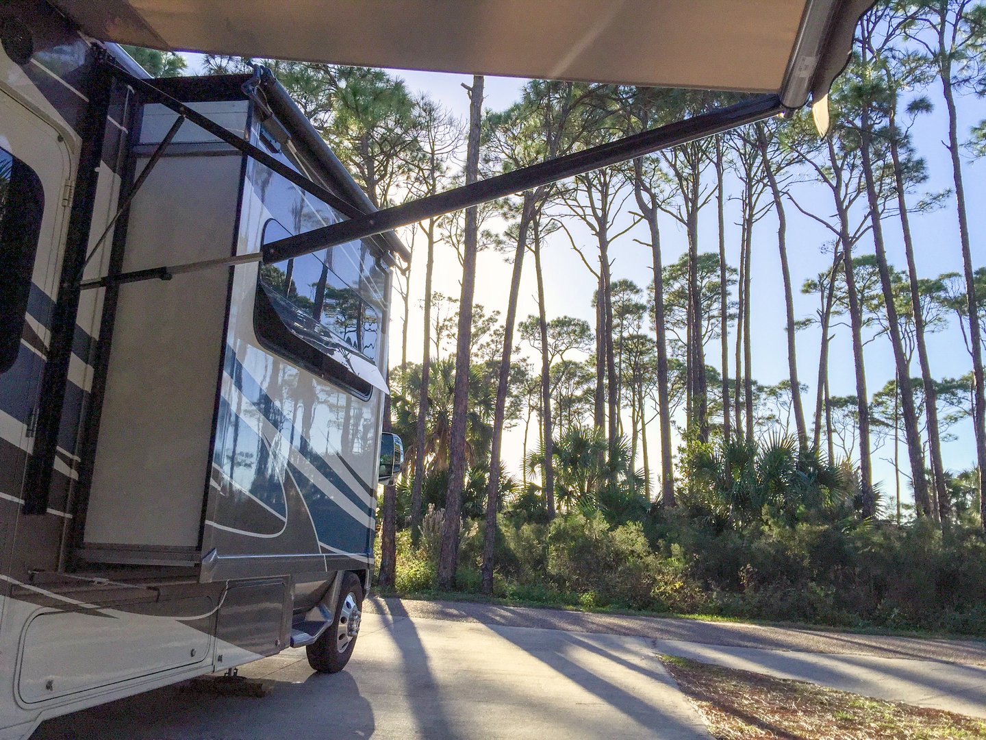 A motor home RV or caravan is parked at a quiet campsite at the T.H Stone Memorial State Park along the area known as the Florida Panhandle.