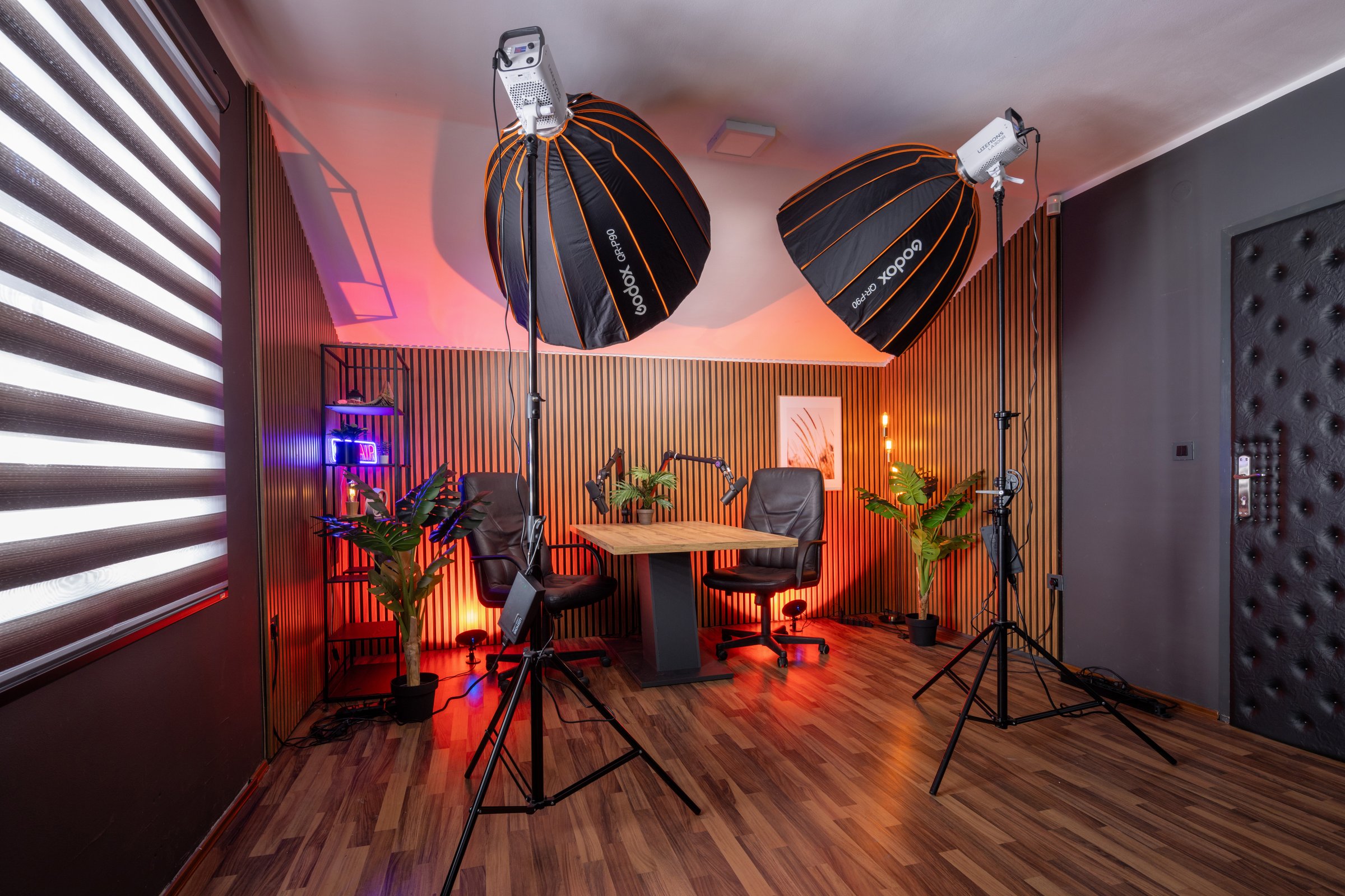 Modern podcast recording studio with professional lighting