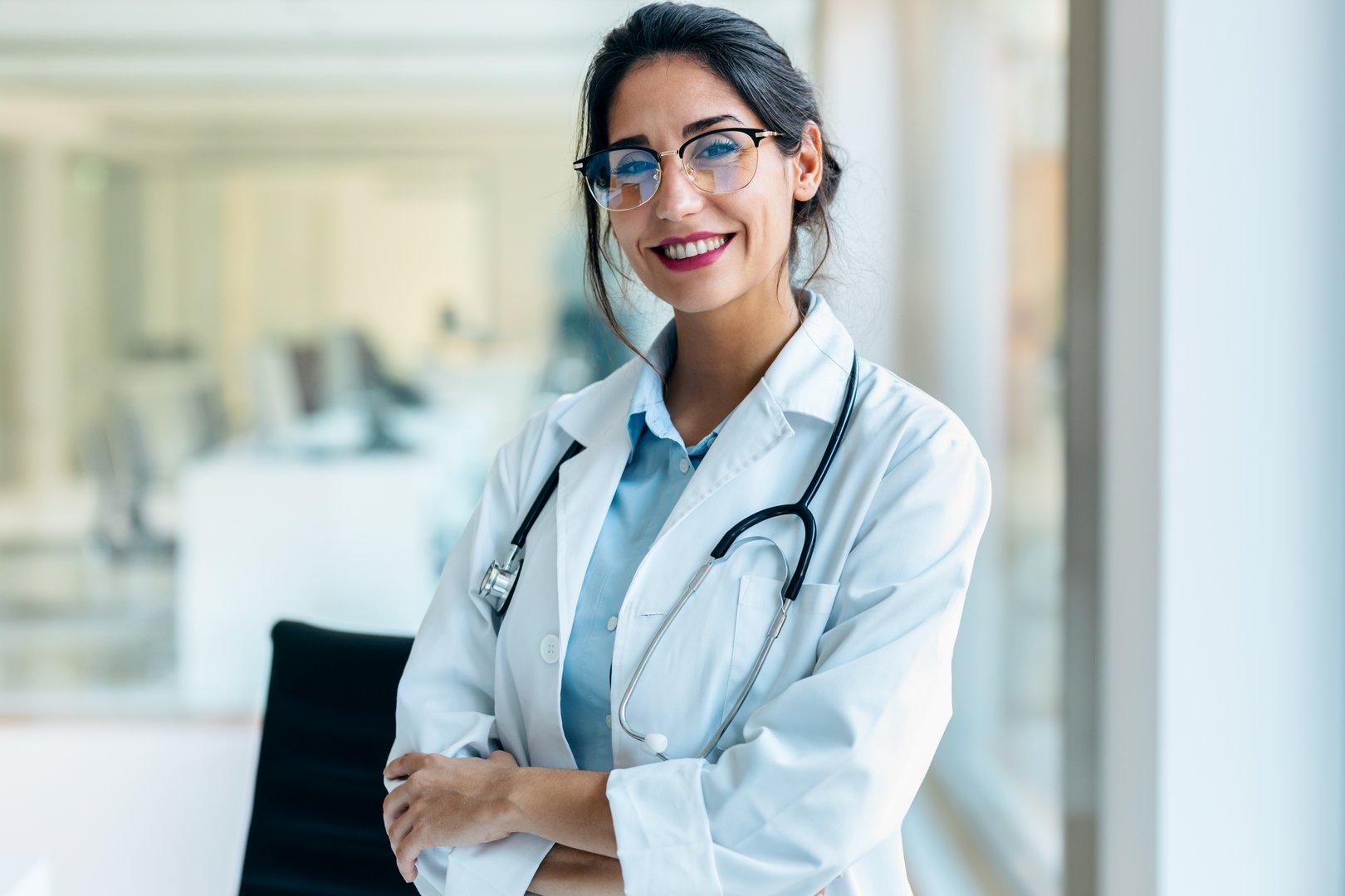 Shot of smiling female doctor looking at camera in the medical consultation.