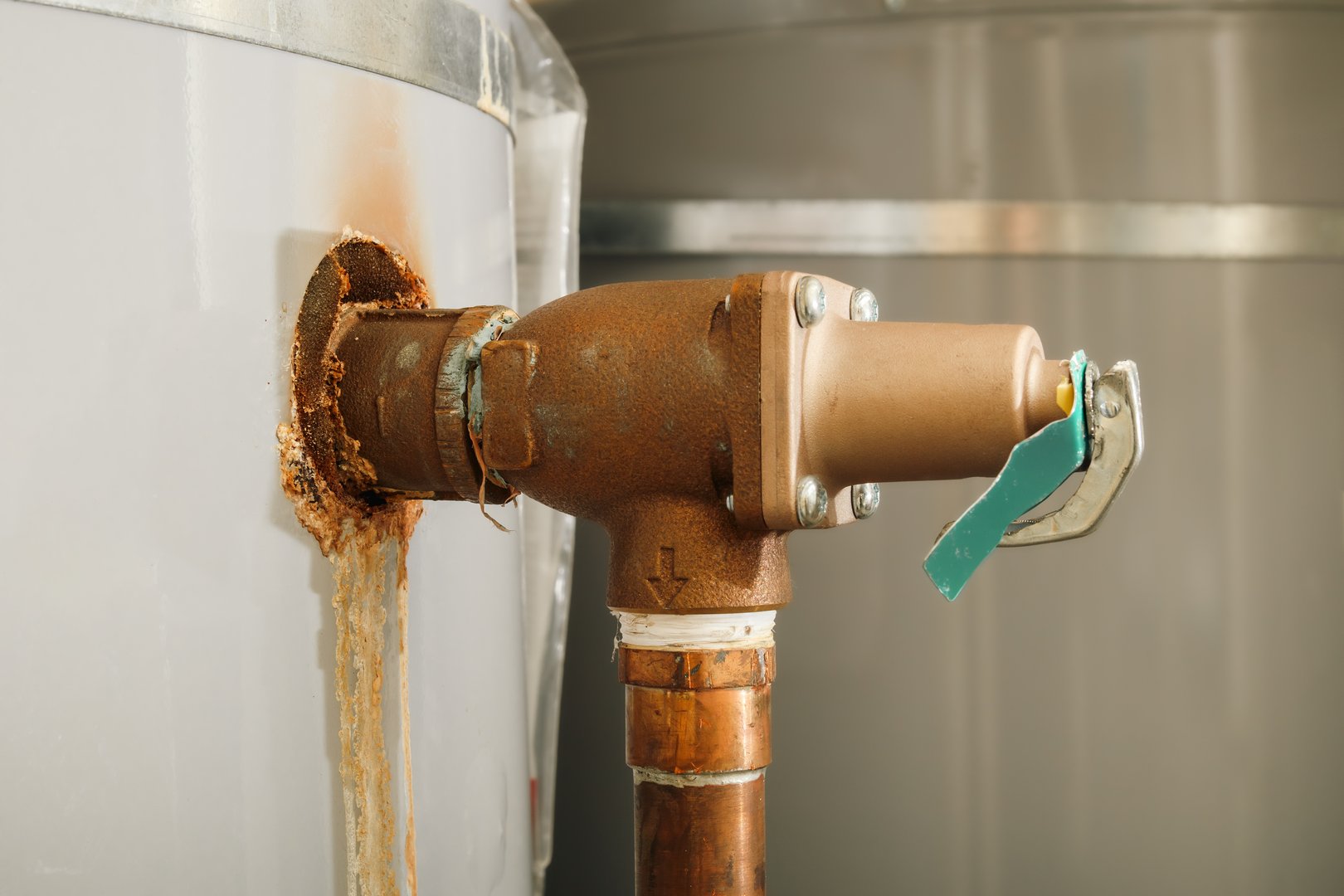 Close up. Safety device to relief pressure exceeds a safe limit. Corrosion on pipe to the valve. Selective focus.