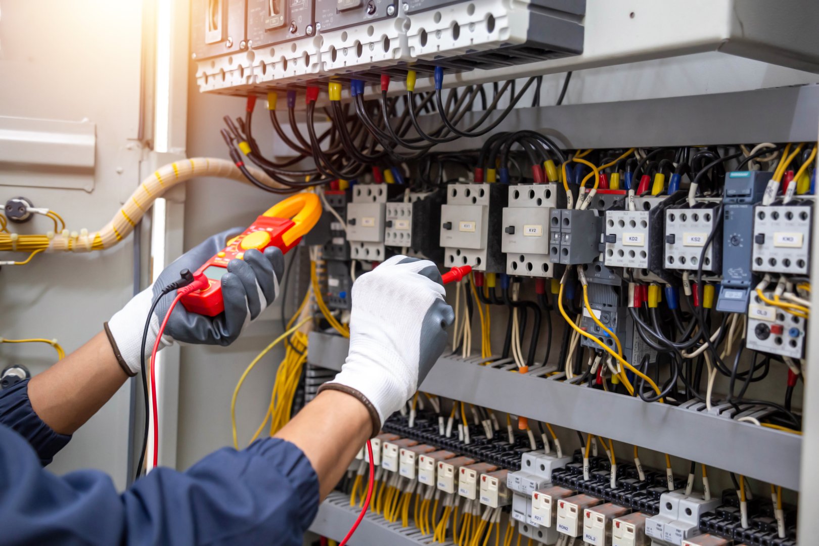 Electrician testing electrical panel
