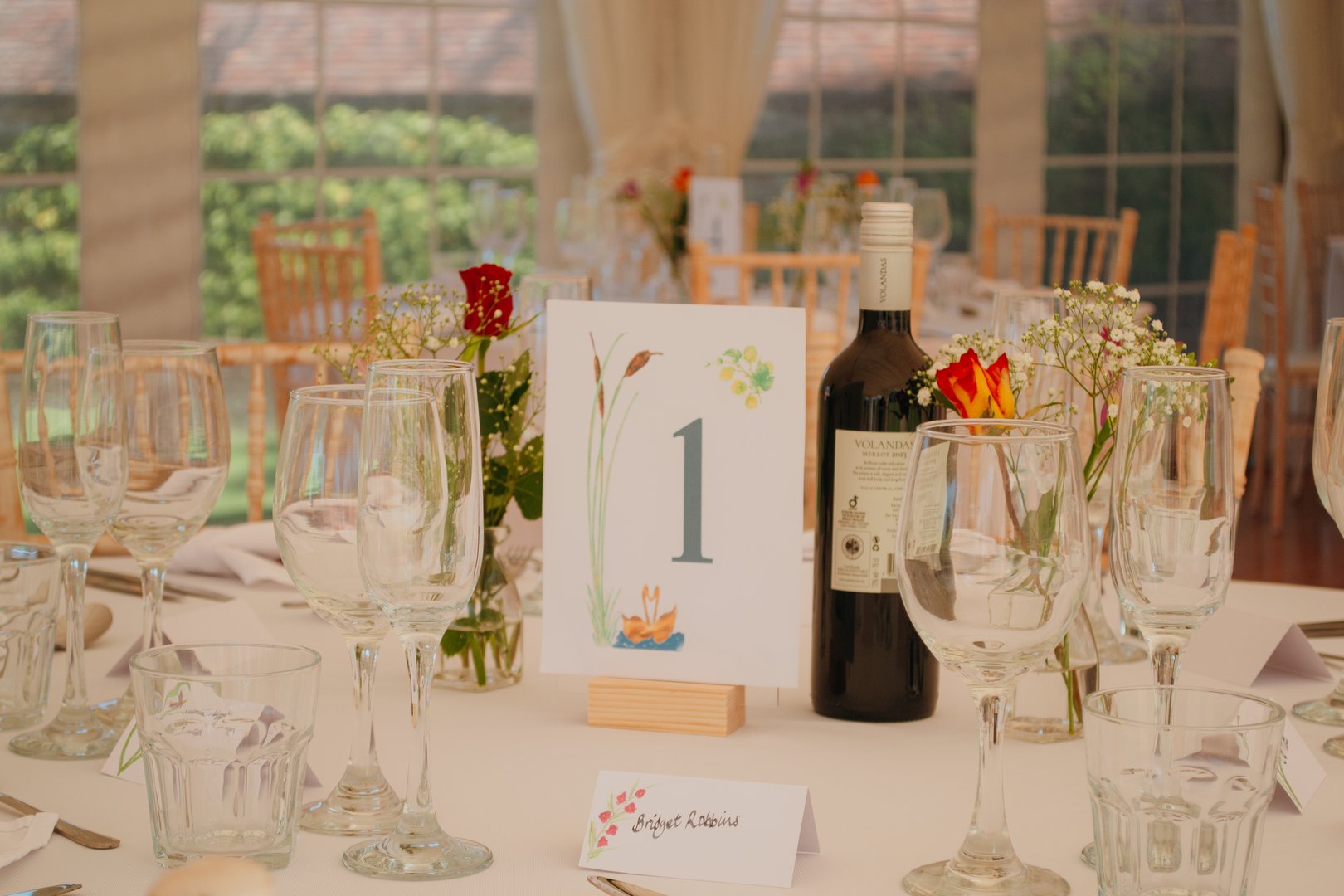 Close-up of a table number 1 displayed on a wedding day reception table. Elegant and organized detail for marriage celebration seating arrangements and festive décor.