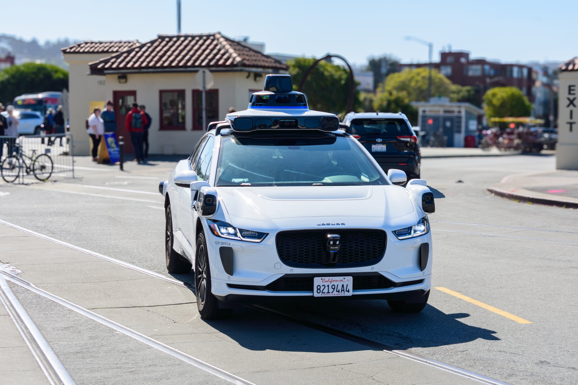 Waymo One Jaguar driverless autonomous car equipped with lidar sensors and cameras drives on a road. Front side view. Selective focus - San Francisco, California, USA - March 8, 2025