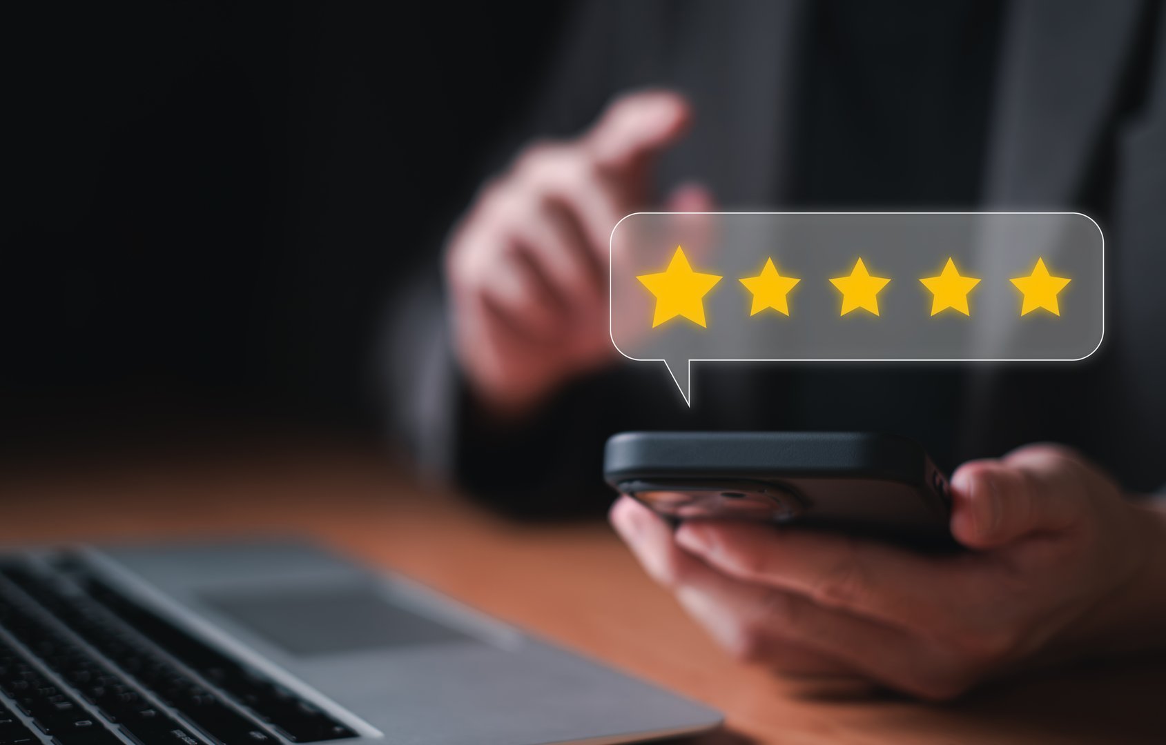 Selective focus at finger of business man while point finger to choose feedback on five star excellent customer service with five star score with smile. Service evaluation concept with futuristic icon