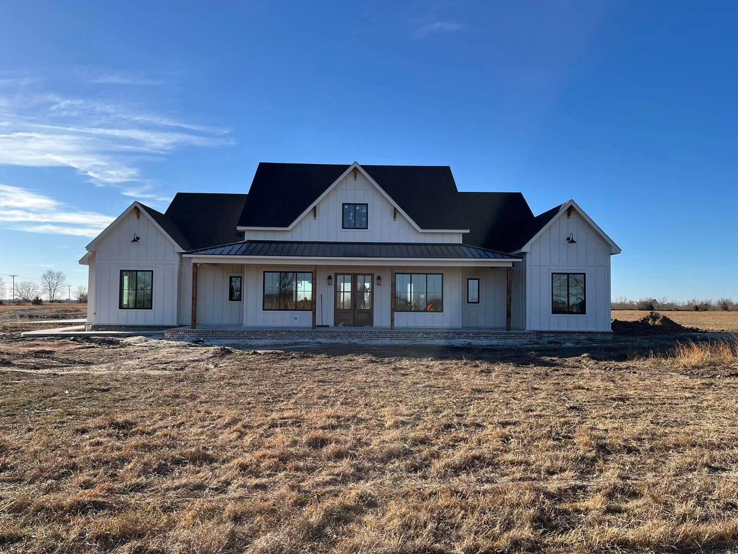 Private Country House Standing in a Scenic Countryside Location on a Beautiful Summer Day with Blue Sky. Suburban Family Home Landscape. High Angle Shot.