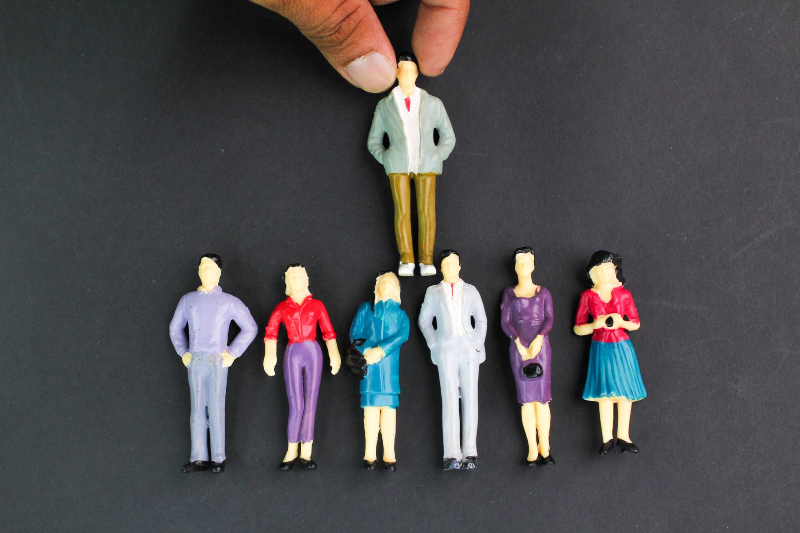 miniature people and a leader. the concept of placing a leader in a group. Human resources and corporate hierarchy concept - recruiter complete team by one leader person (successor, CEO)
