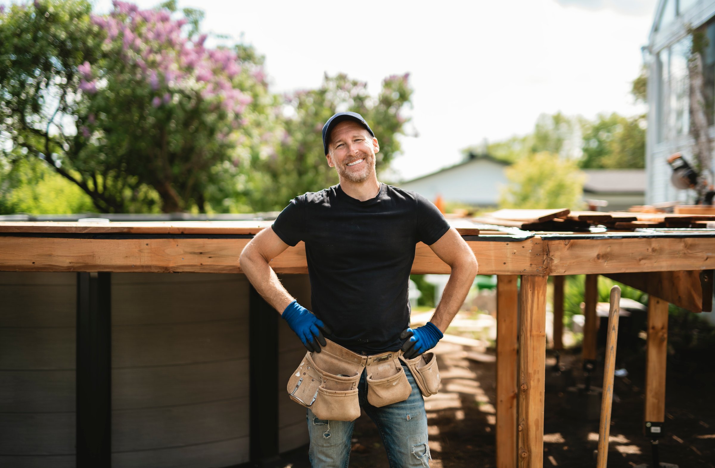 A Handyman worker making patio outside close to a pool