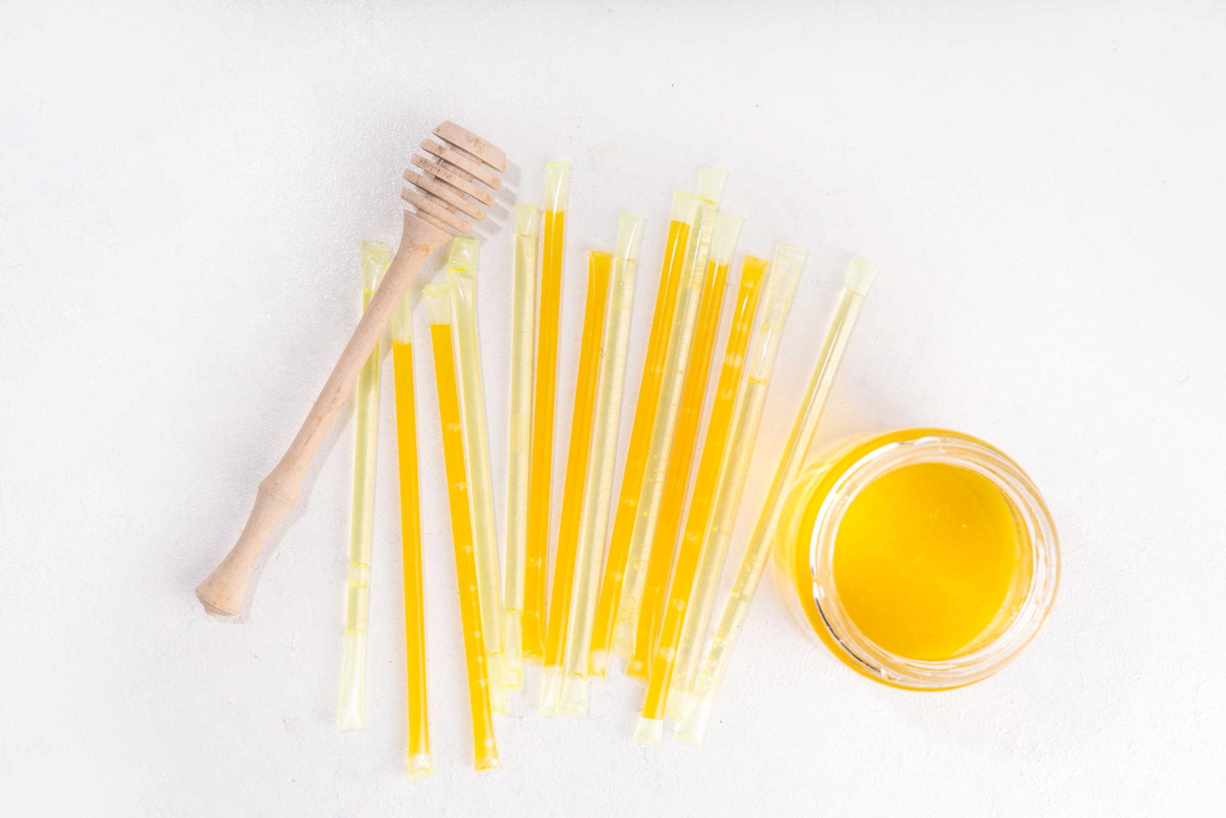 Homemade honey sticks. Portable straws with golden honey, healthy organic treat